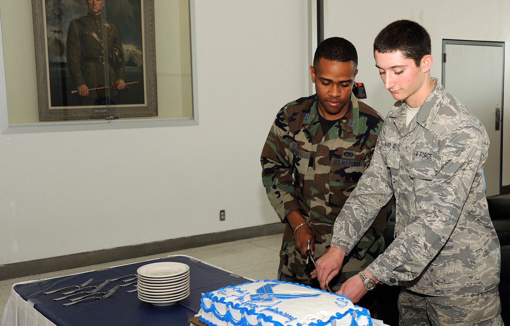 Cadet 1st Class Christopher Hunter from Cadet Squadron 33 and Cadet 4th Class Timothy Ambard from Cadet Squadron 38 cut a cake during a party for the Air Force's 62nd birthday at the Academy in Colorado Springs, Colo., Sept. 18, 2009. Cadet Hunter is the oldest attending Academy ccadet, and Cadet Ambard is the youngest. (U.S. Air Force photo/Mike Kaplan)