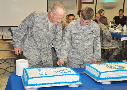 SOTO CANO AIR BASE, Honduras — The oldest Airman, Col. Steven Curtis, and the youngest Airman, Senior Airman Kristopher Rainwater, cut the birthday cake for the Air Force’s 62nd birthday celebration at the dining facility here Sept. 18. Service members and civilians were served steak and lobster for lunch and a brief ceremony took place during the lunch hour on Air Force history, and Senior Airman Angel Suarez, 612th Air Base Squadron, spoke about a recent deployment to Iraq (U.S. Air Force photo/Staff Sgt. Chad Thompson).