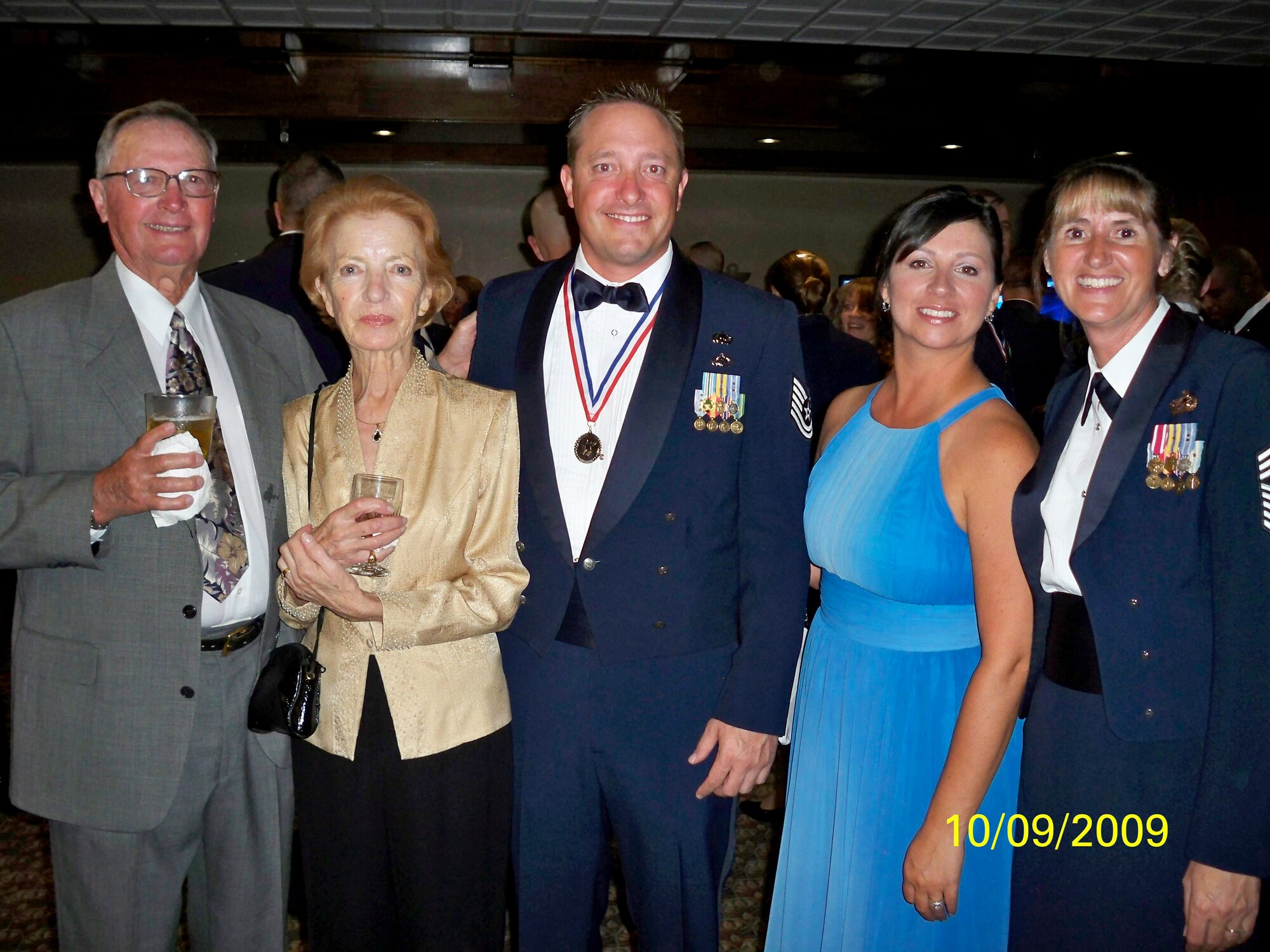 Tech. Sgt. Sebastian Garcia, 140th Wing Colorado Air National Guard, poses with his family and 140th WG Command Chief Master Sgt. Annadele Kenderas (right) during the Peterson NCO Academy graduation Sept. 10. (Photo courtesy of Chief Master Sgt. Arleen Heath)