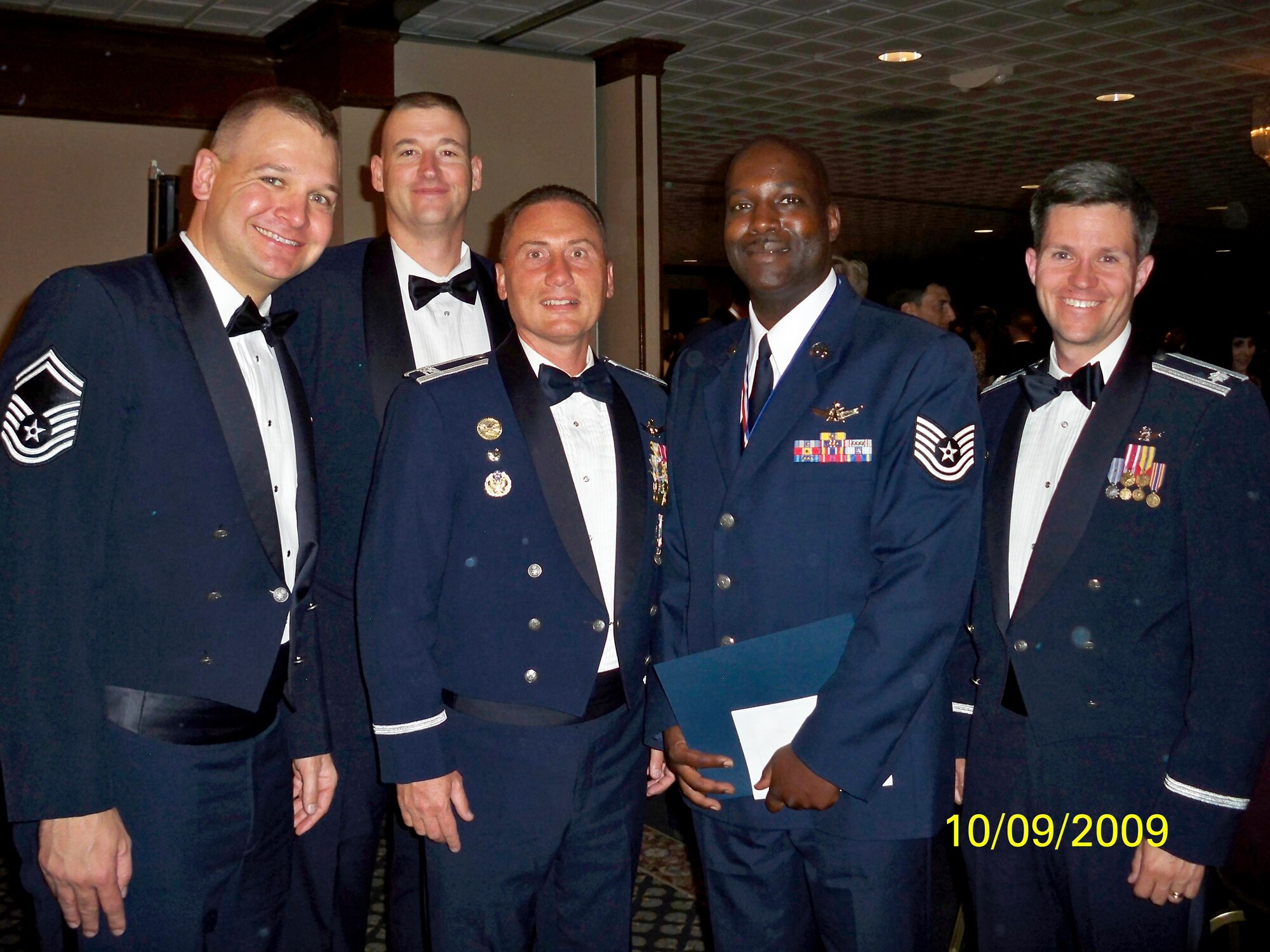 Tech. Sgt. Miguel Toller, 11th Space Warning Squadron (center right) poses with Col. Clint Crosier, 460th Space Wing commander (center left), and members of his squadron during the Peterson NCO Academy graduation Sept. 10. (Photo courtesy of Chief Master Sgt. Arleen Heath)