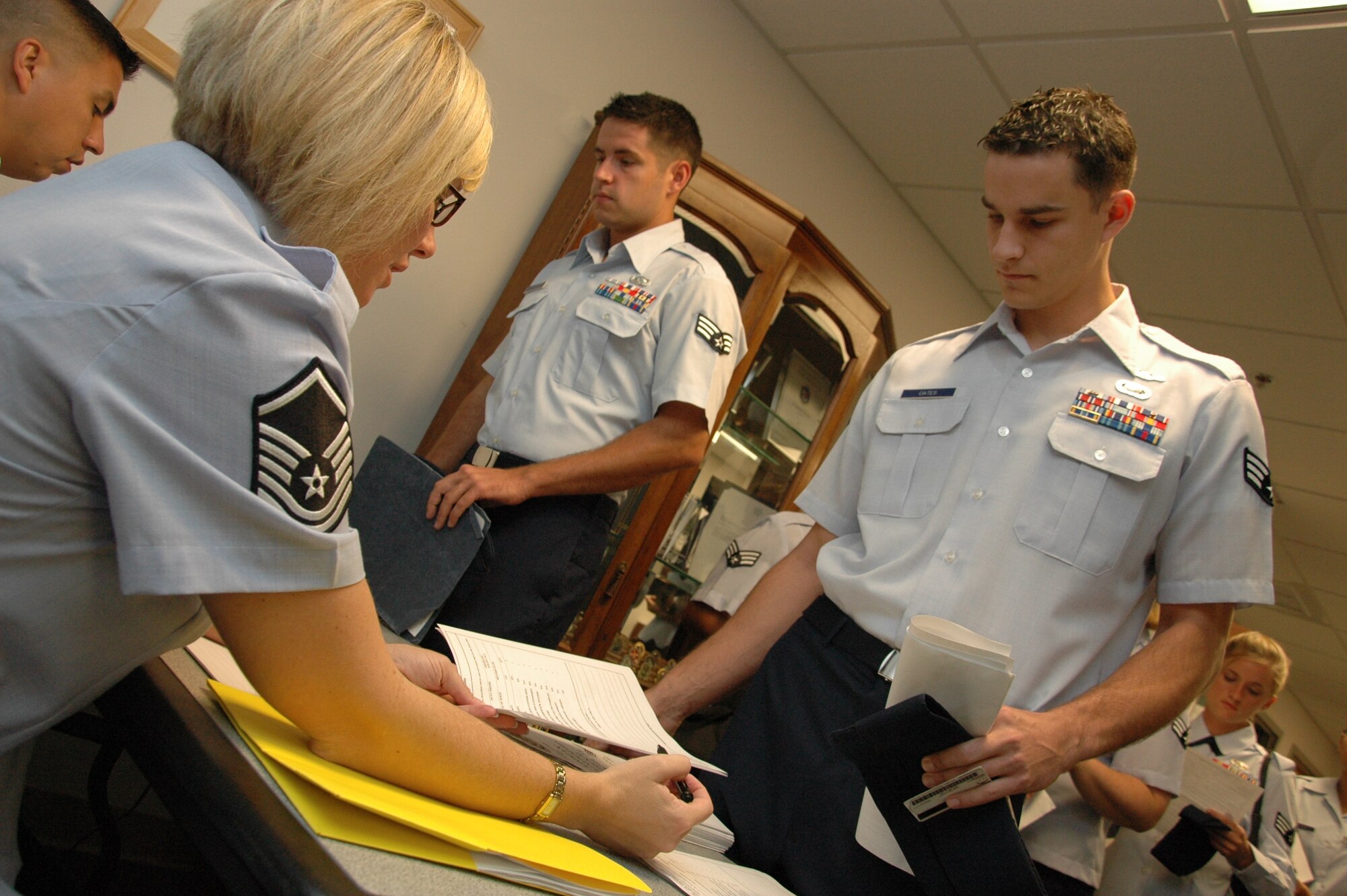 Master Sgt. Lisa Buckman, Airman Leadership School Commandant, goes over an in-processing form with a new ALS student Sept. 16.  Then new ALS Class 10-Alpha begins their month-long journey to becoming non-commissioned officers here. The 48 students will graduate from ALS Oct. 21. (Air Force photo/ Staff Sgt. Bryan Franks)