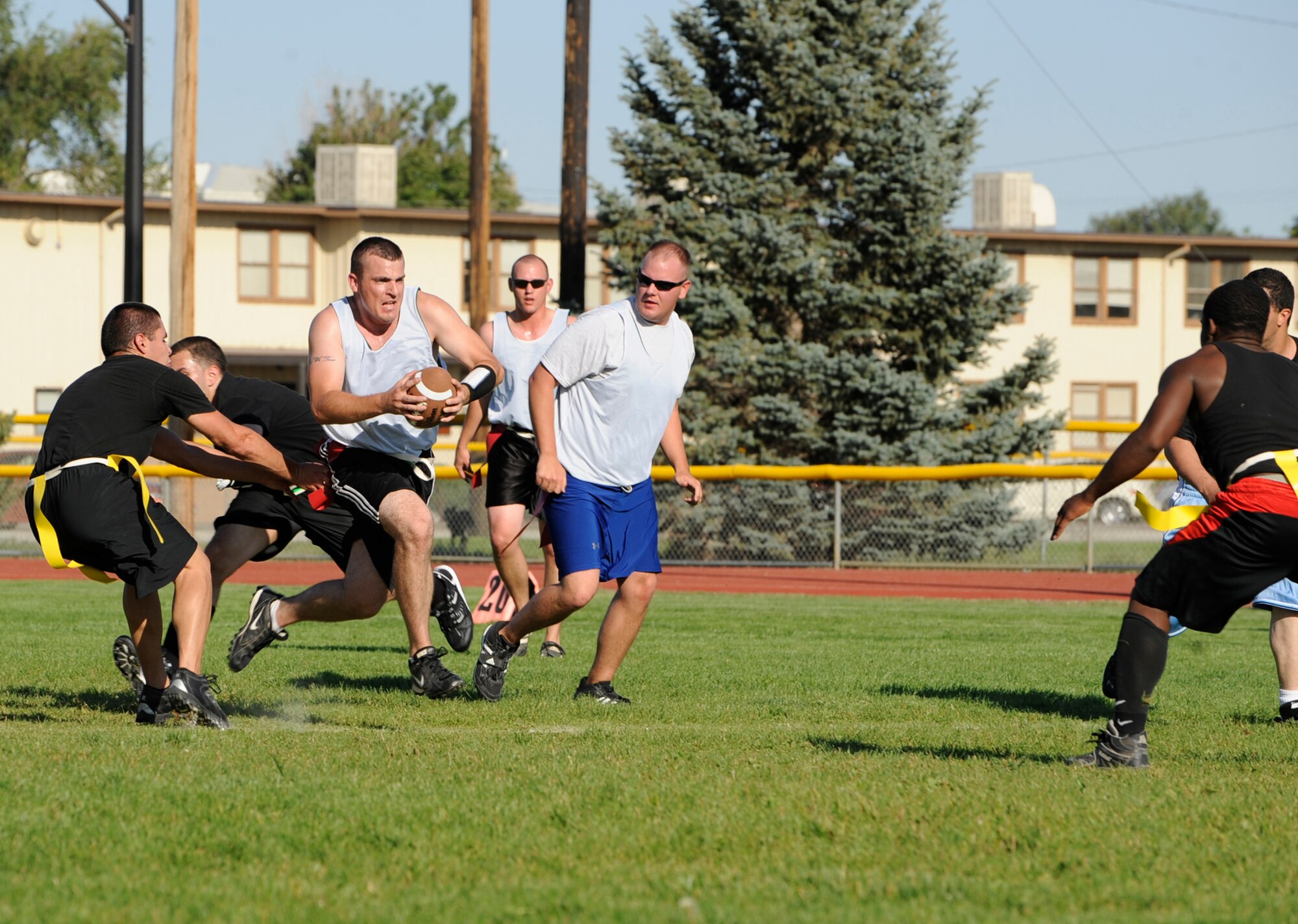 MOUNTAIN HOME AIR FORCE BASE, Idaho -- Chad Curtis, 366th Communications Squadron quarterback, runs past defenders from the 366th Fighter Wing Sept. 15 during an intramural flag football game. FW opened the season with an 8-0 win over CS. (U.S. Air Force photo by Airman 1st Class Renishia Richardson)