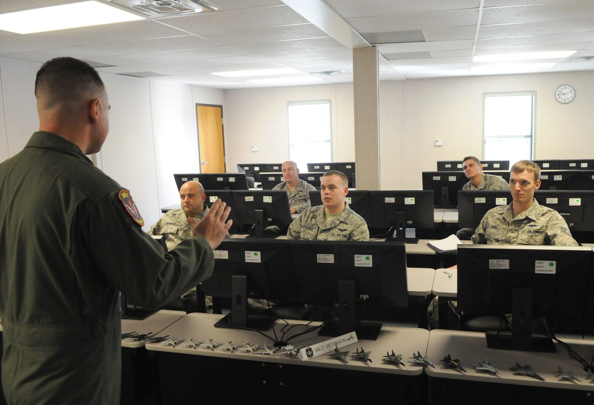 Tech. Sgt. Michael Arroyo (left), a Basic Sensor Operator Training course instructor, gives a final briefing to students (from left to right) Staff Sgt. Jason Peterson, Staff Sgt. Adam Rosen, Airman 1st Class Ronald Shortledge, Senior Airman Robert Babian and Staff Sgt. Jeremy Reid, prior to their graduation Sept. 18, following 20 days of academic instruction. Upon graduation, students in this inaugural class will earn the Air Force Specialty Code 1U0X1, sensor operators.  (U.S. Air Force photo/Rich McFadden)