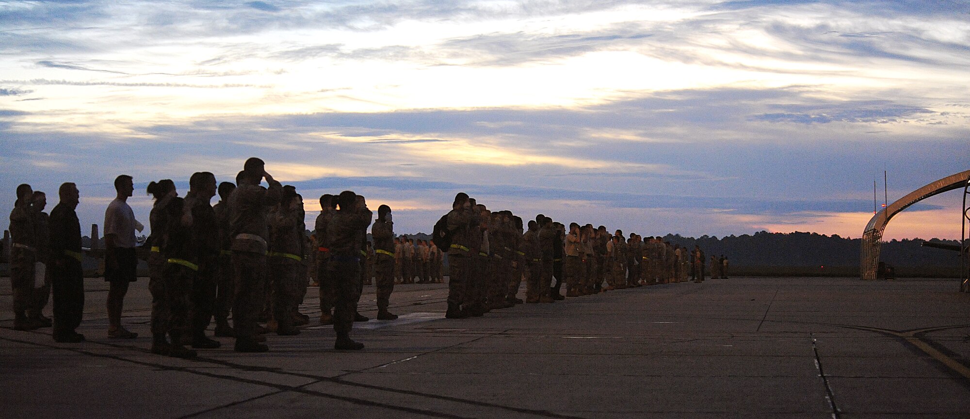 MOODY AIR FORCE BASE Ga. -- Airmen from the 23rd Wing salute during the playing of reveille before participating in a foreign object debris walk on the flightline here Sept. 18. The FOD walk was held in preparation for the upcoming Operational Readiness Inspection. (U.S. Air Force photo by Airman 1st Class Joshua Green)