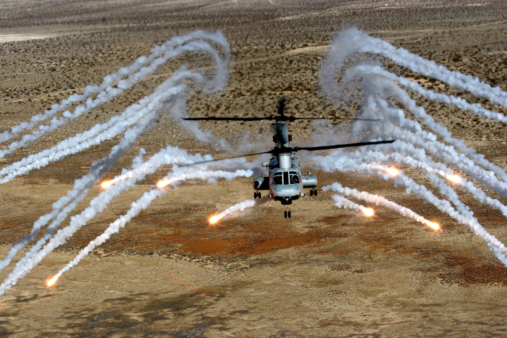 A CH-46E Sea Knight dispenses infrared countermeasures during a multiplatform countermeasure effective test conducted by the Army, Navy and Marine Corps at White Sands Missile Range in New Mexico. All aircraft used were hosted at Holloman Air Force Base, N.M, including the UH-1Y Venom, CH-53E Super Stallion, MV-22 Osprey, CH-47 Chinook, UH-60 Black Hawk and AH-64 Apache. More than 1,500 infrared countermeasures were dispensed from the aircraft under various test conditions, providing valuable information to be used in theater. (U.S. Marine Corps photo) 