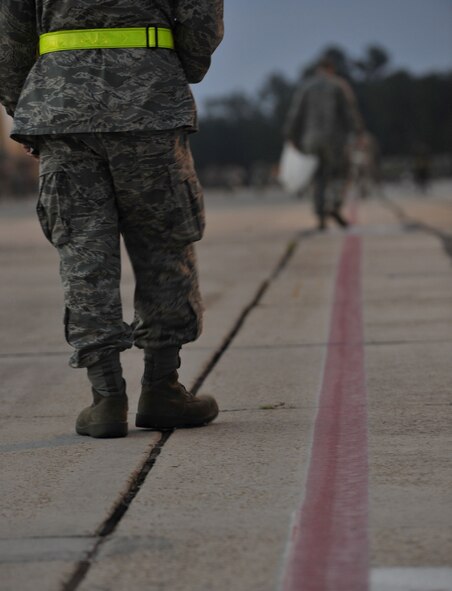 MOODY AIR FORCE BASE, Ga. -- Staff Sgt. Dominick Della-Pia, 23rd Fighter Group intelligence analyst, along with other Airmen from the 2rd Wing participate in a foreign object debris walk on the flightline here Sept. 18. The FOD walk was held in preparation for the wing’s upcoming Operational Readiness Inspection. (U.S. Air Force photo by Senior Airman Schelli Jones)
