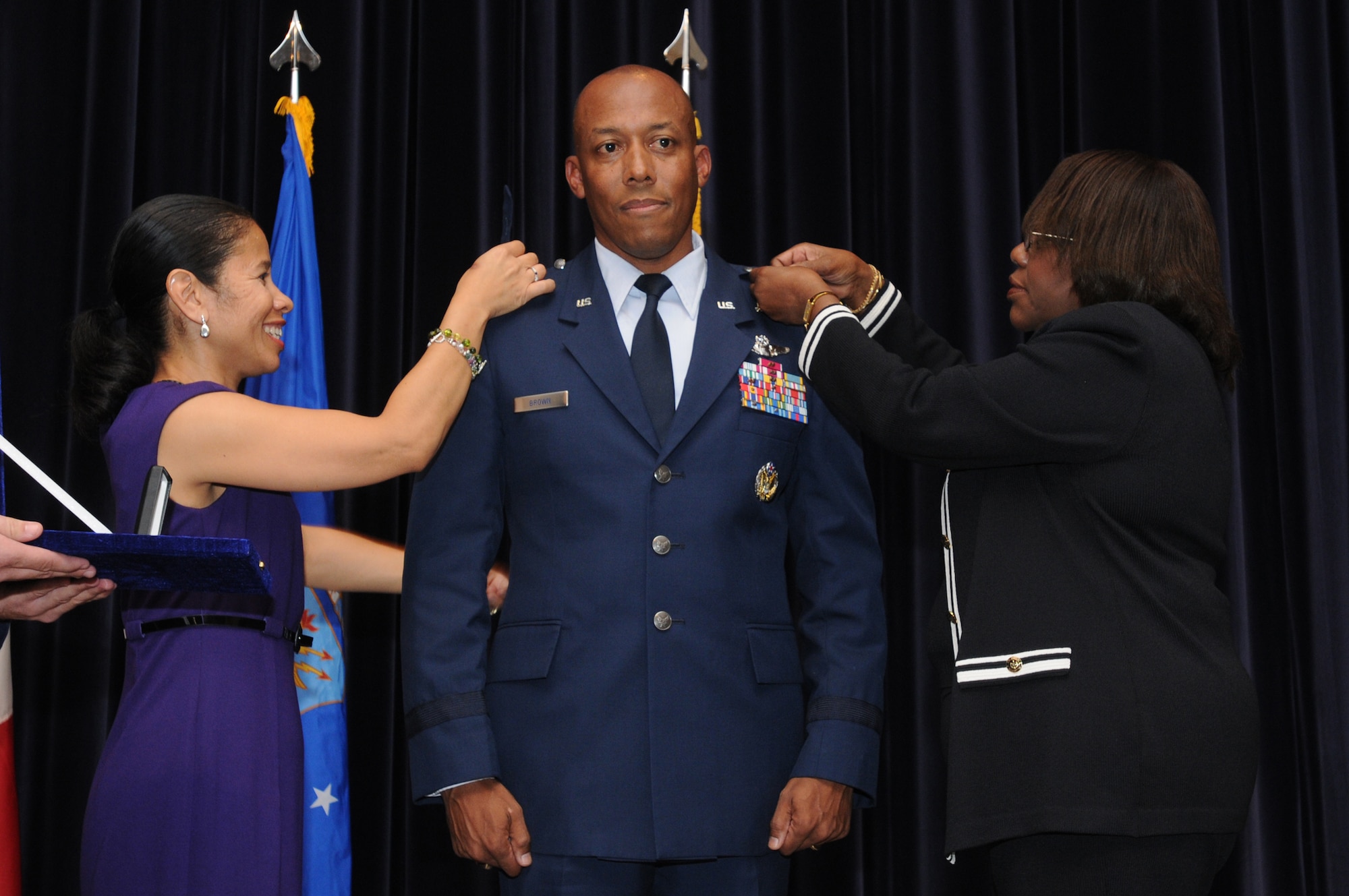 Brig. Gen. Charles Q. Brown Jr., 31st Fighter Wing commander's wife (left) and mother (right) pin on his first star following the orders being published for his promotion Sept. 18, 2009, at Aviano Air Base, Italy.  Lt. Gen. Frank Gorenc, 3rd Air Force commander, Ramstein Air Base, Germany presided over the ceremony.  (U.S. Air Force photo/Staff Sgt. Patrick Dixon) 