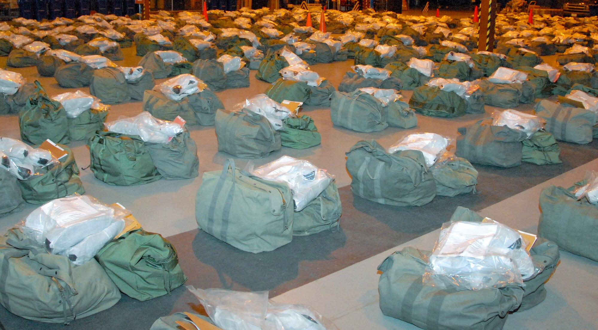 Nightime made no difference as aircraft loading continued, a "K-loader" is maneuvered inside a C-5, 908th mobility bags are pulled from storage and prepared for loading, a portable heater and electric generator are positioned and 908th members ensure a cargo pallet is securely fastened. (U.S. Air Force photo/Jamie Pitcher)
