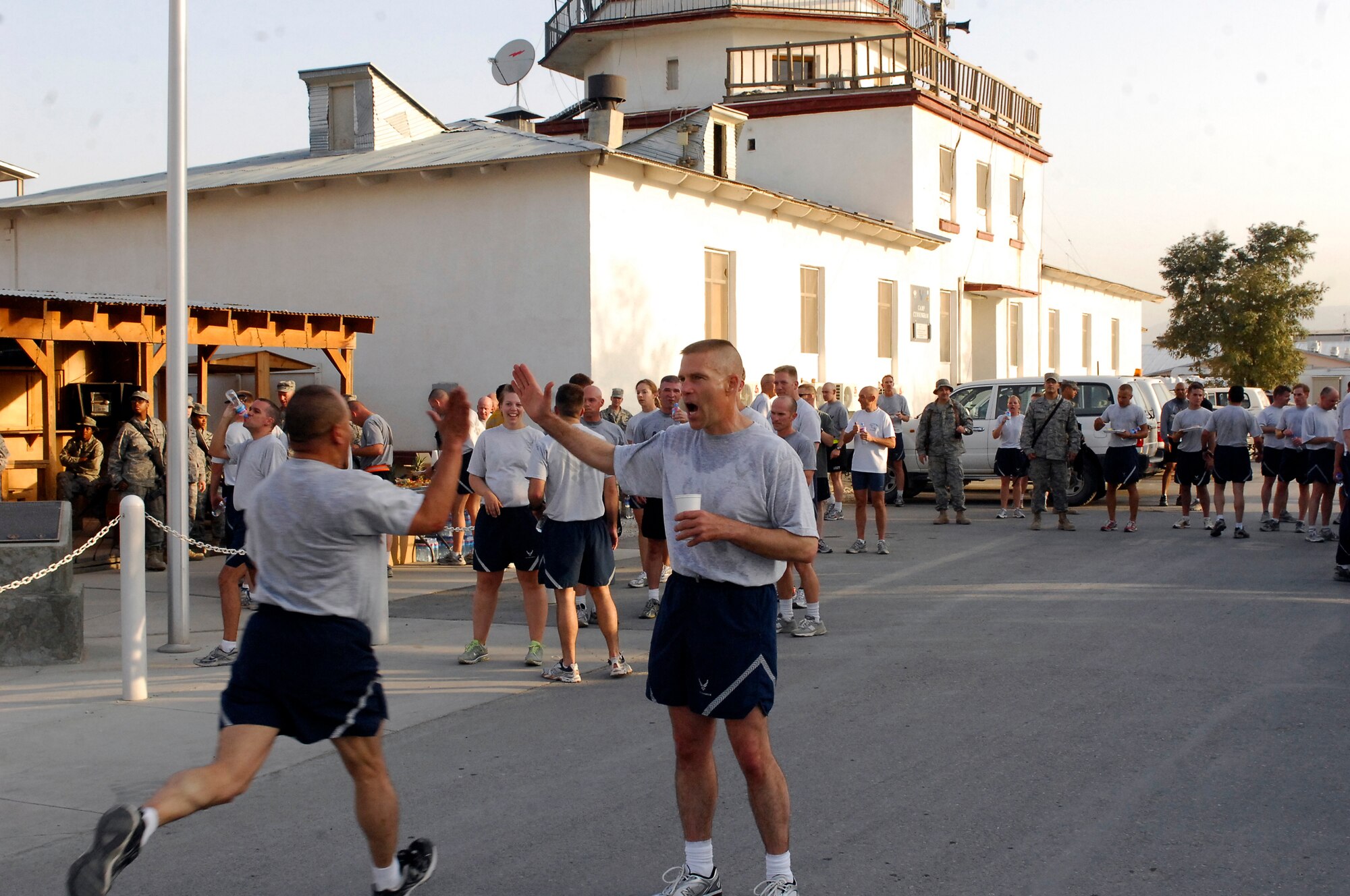 Brig. Gen. Steven L. Kwast encourages an Airman to finish strong as he completes a 5 kilometer run on the 62nd Air Force birthday Sept. 18, 2009, at Bagram Airfield, Afghanistan. Airmen here were challenged by the general to run for a month leading up to the Air Force birthday and then run the 5 kilometer run with him after a reveille ceremony to complete the challenge. General Kwast is the 455th Air Expeditionary Wing commander. (U.S. Air Force photo/Senior Airman Felicia Juenke) 