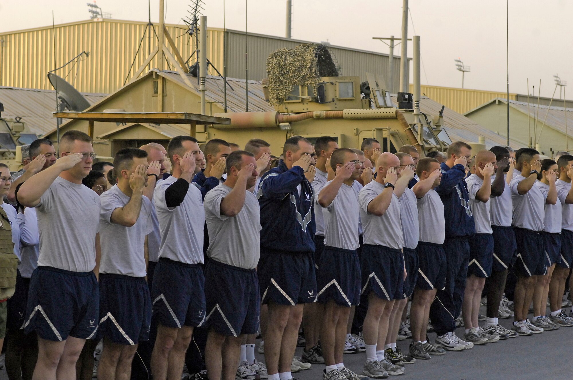 Several hundred Airmen salute as the U.S. flag is raised on the 62nd Air Force birthday Sept. 18, 2009, at Camp Cunningham, Afghanistan. The Airmen ran a 5 kilometer run afterward to show their strength and determination to continue taking the fight to the enemy every day. (U.S. Air Force photo/Senior Airman Felicia Juenke) 