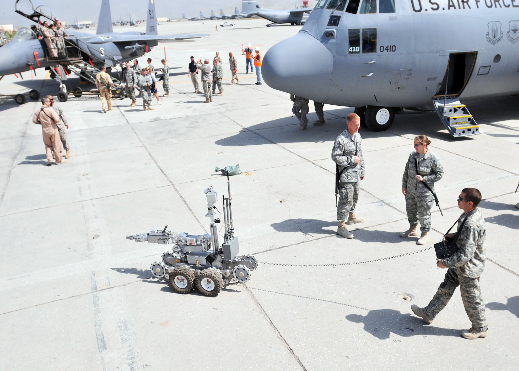 Staff Sgt. Ryan Oliver demonstrates the capabilities of their robot for a crowd at an open house ceremony in honor of the Air Force's 62nd birthday Sept. 18, 2009, at Bagram Airfield, Afghanistan. Sergeant Oliver is an explosive ordnance disposal team leader from the 755th Air Expeditionary Group. (U.S. Air Force photo/Captain David Faggard) 