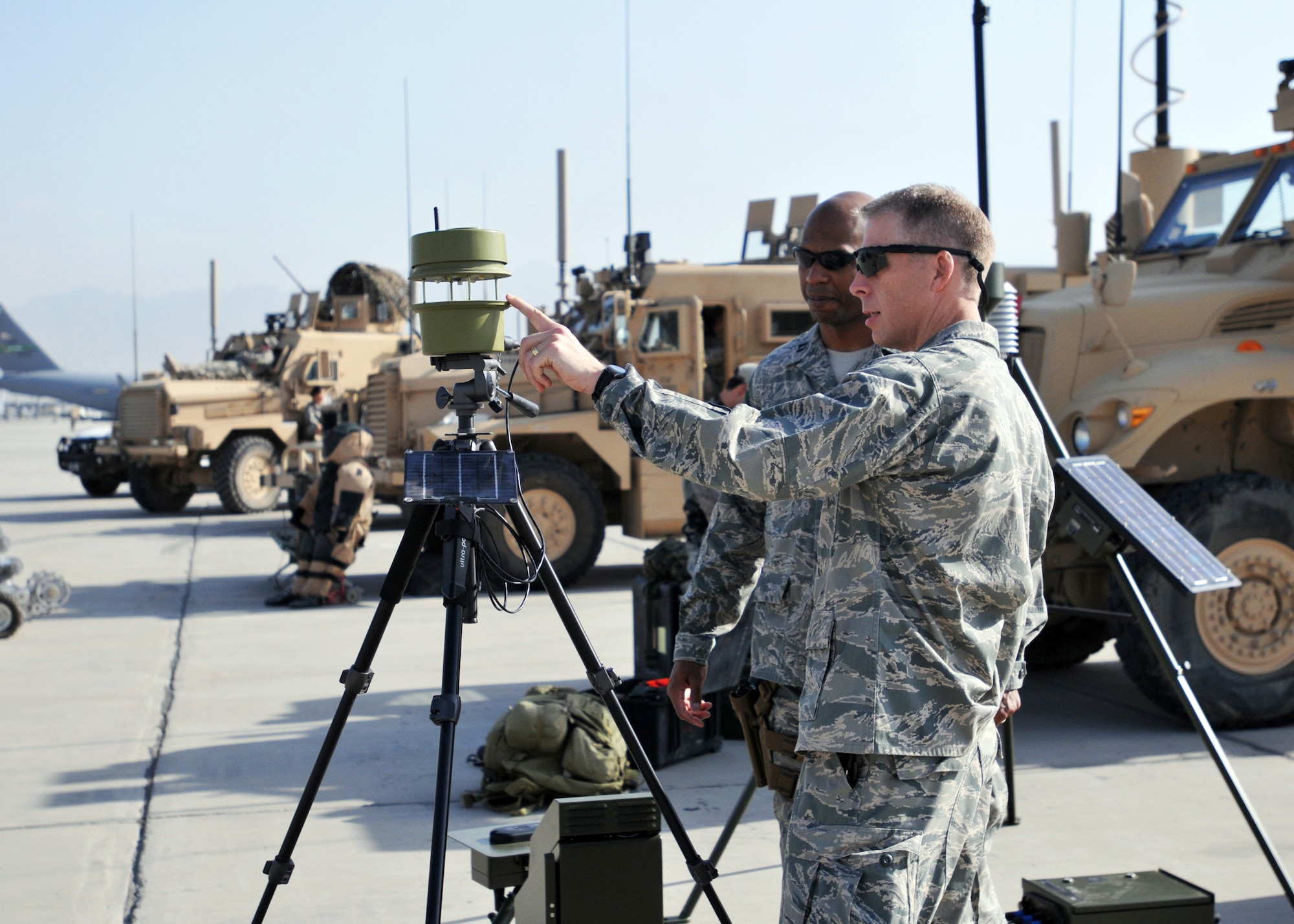 Lt. Col. Brian Griffith discusses battlefield weather capabilities with Capt. Jacob Chisolm at the Air Force's 62nd birthday Sept. 18, 2009, at Bagram Airfield, Afghanistan. Colonel Griffith is the 19th Expeditionary Weather Squadron commander, and Captain Chisolm is the 504th Expeditionary Air Operations Support Group executive officer. (U.S. Air Force photo/Capt. David Faggard) 