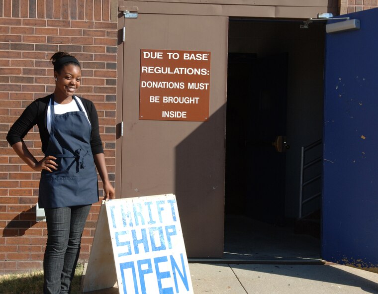 Regan Porter, B-One Yard manager, shows off the welcome sign for the B-One Yard thrift and consignment shop here, Sept. 9. The B-One Yard reopened Aug. 24.
(U.S. Air Force photo/Airman 1st Class Jarad Denton)