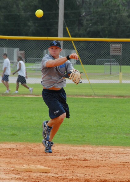 Senior Airman Michael Melton makes a throw to first base during an Air Force Softball Team practice session Sept. 16 at Eglin Air Force Base.  Airman Melton is an AF softball team member as well as a firefighter with the 96th Civil Engineer Squadron stationed here.  Eglin is the site for tryouts and practices leading up to the All Services Tournament held in Pensacola, Fla., beginning Sept. 20.  Fifteen Air Force members from 11 different bases made the team this year.  Four ‘rookies’ made the team this year along with 11 team veterans.  (U.S. Air Force photo/Samuel King Jr.)