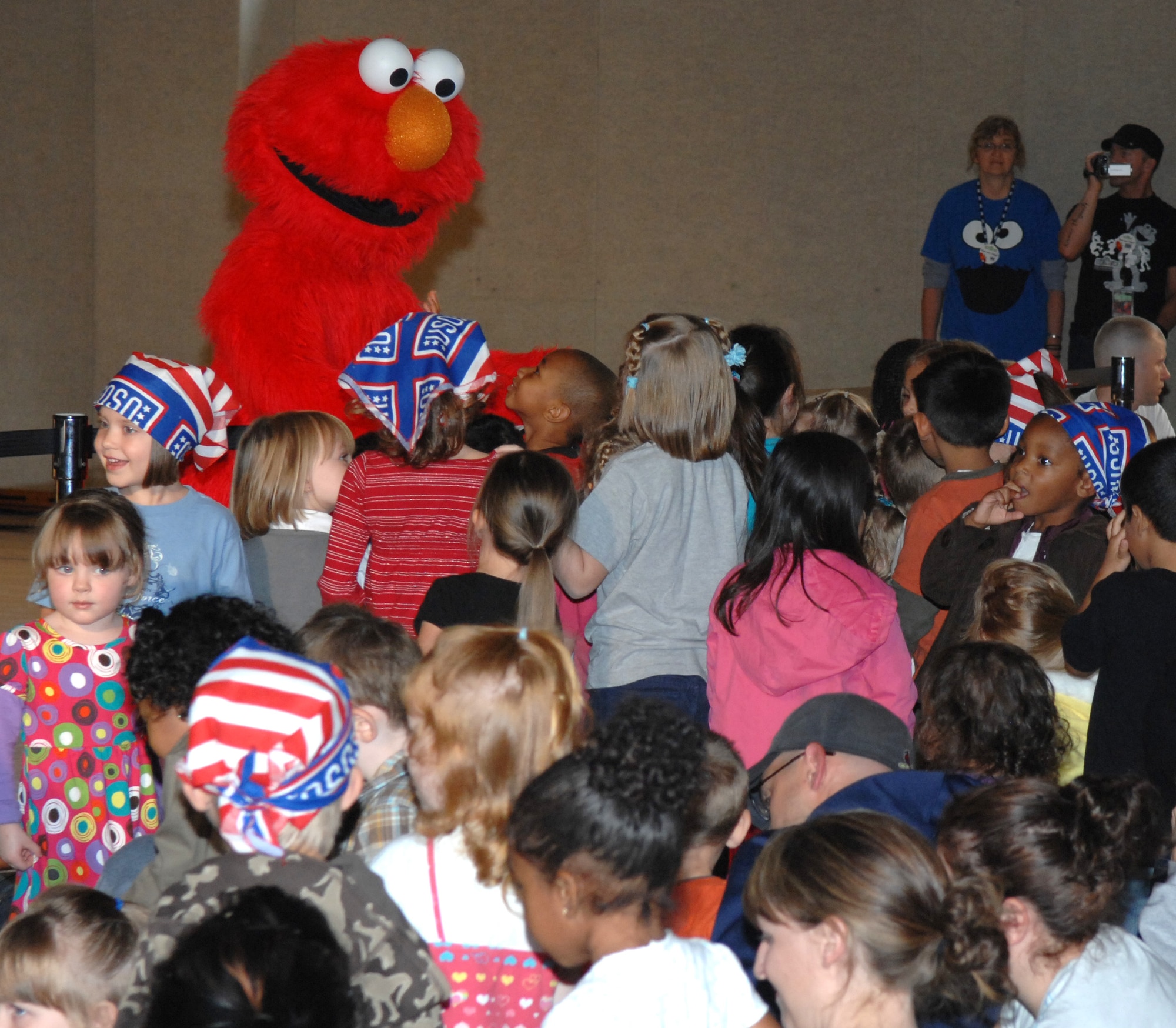 SPANGDAHLEM AIR BASE, Germany – Elmo, a Sesame Street character, walks into the crowd to greet his fans during the Sesame Street Experience USO-sponsored tour at the Bitburg gym Sept. 16. The Sesame Street Experience is a free traveling tour dedicated to helping military families deal with the emotional stresses that come with being a military parent or child of a deployed servicemember. Bitburg Annex was the fourth stop on the group’s European tour with 16 bases remaining.  (U.S. Air Force photo/Airman 1st Class Staci Miller)