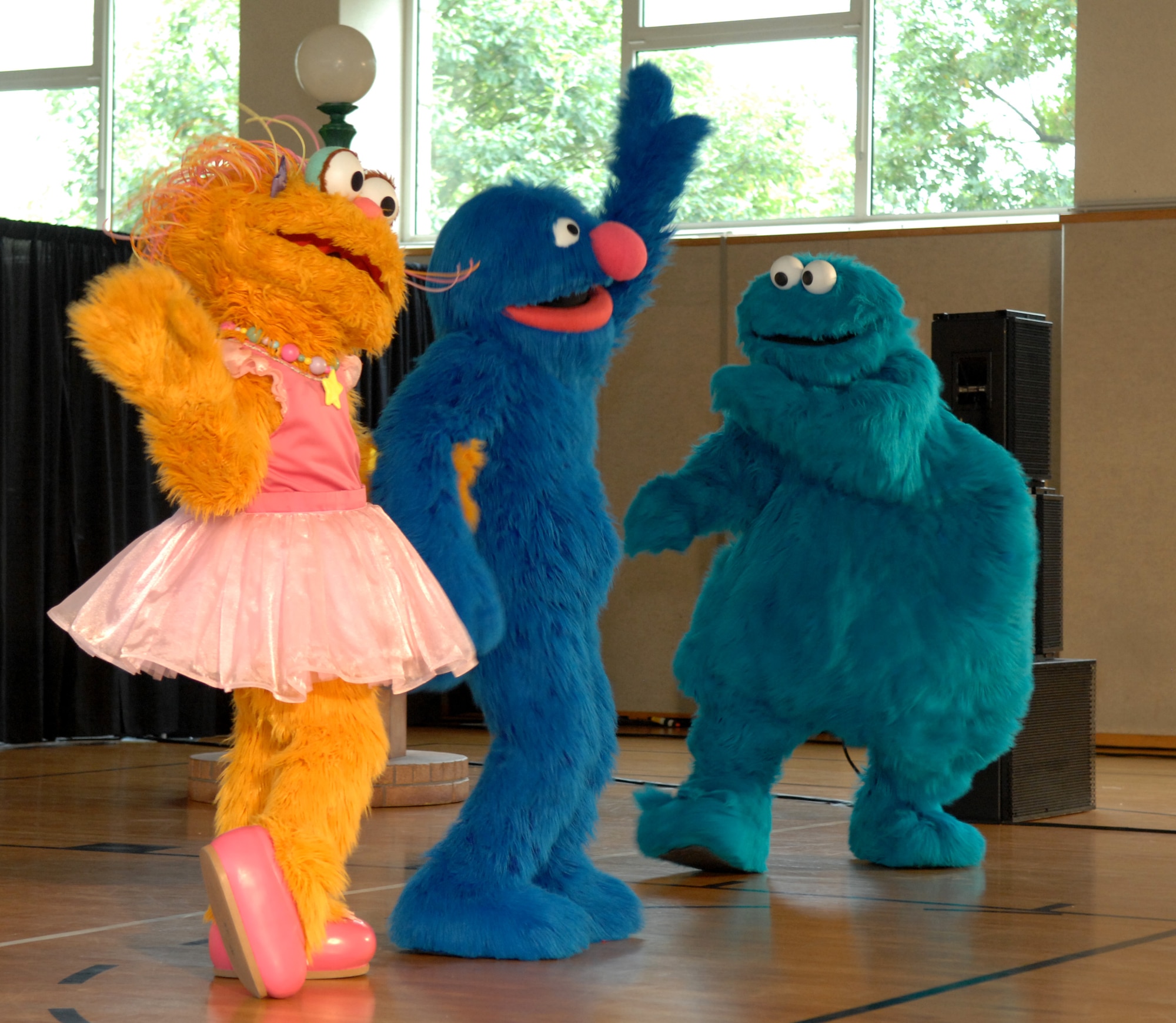 SPANGDAHLEM AIR BASE, Germany – Zoe, Grover and Cookie Monster, Sesame Street characters, perform live at the Bitburg Annex gym for a full house of children and their families Sept. 16.  The Sesame Street Experience is a free traveling USO-sponsored tour dedicated to helping military families deal with the emotional stresses that come with being a military parent or child of a deployed servicemember. Bitburg Annex was the fourth stop on the group’s European tour with 16 bases remaining. (U.S. Air Force photo/Airman 1st Class Staci Miller)