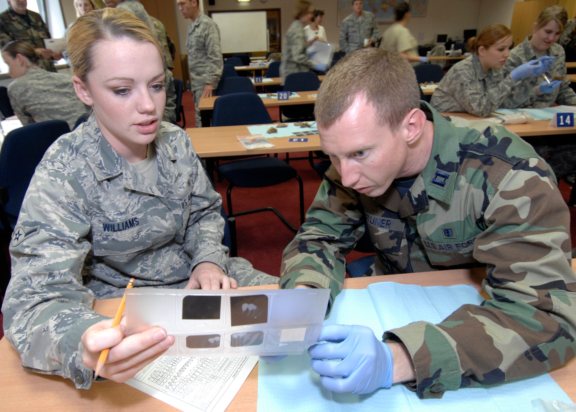 SPANGDAHLEM AIR BASE Germany – 52nd Dental Squadron Dentist, Capt. (Dr.) Jeremy Bruner, and Airman Amy Williams, a dental assistant, examine dental records to identify victims of a simulated plane crash.  Both took part in a forensics exercise during the Air Force Oral Pathology and Forensics Conference at the Eifel Wilkommen Center Sept. 18.  This two-day conference was attended by Air Force and Army dentists and dental technicians.  (U.S. Air Force photo/Master Sgt. Bill Gomez)
