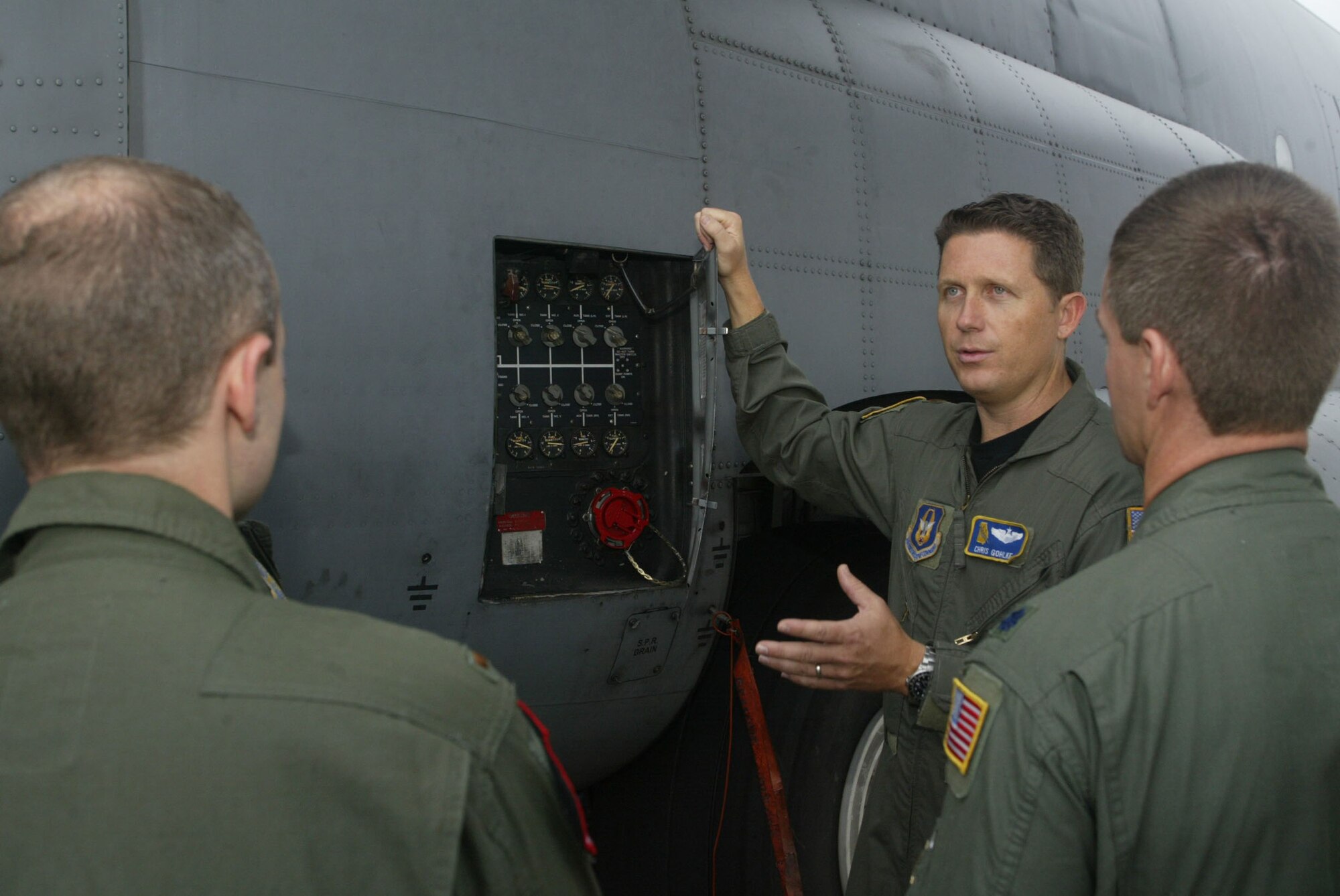 Maj. Christopher Gohlke, 700th Airlift Squadron flight instructor, escorts the newest class of C-130 pilots for a close-up view of their future aircraft Sept. 17. The six student pilots spent the past 10 weeks studying academics and are transitioning into the 20-week portion of hands-on learning to fly the C-130H aircraft assigned here.  After their training, the six pilots will return to Guard and Reserve units throughout the country. (U.S. Air Force photo/Don Peek)