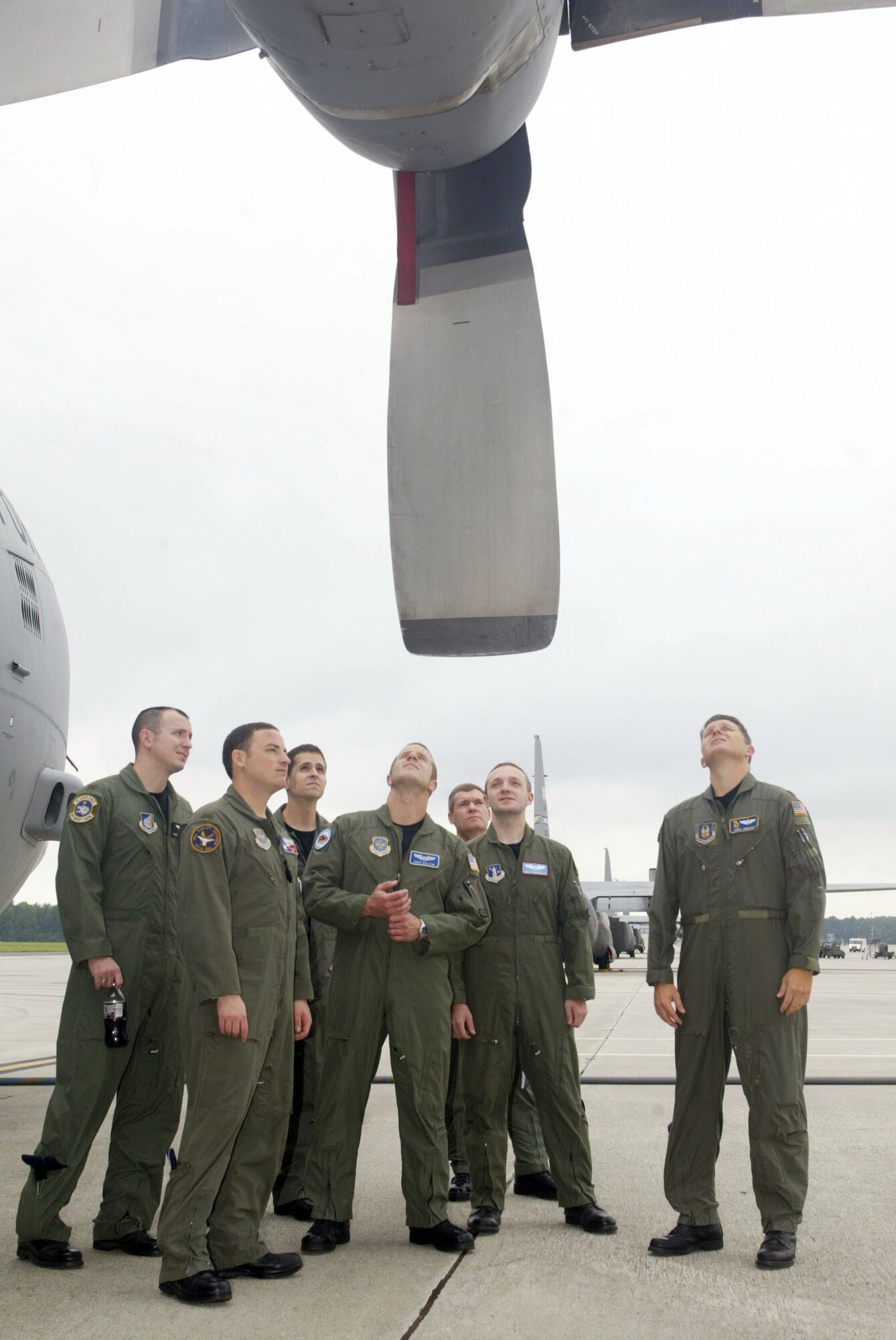 Maj. Christopher Gohlke, 700th Airlift Squadron flight instructor, escorts the newest class of C-130 pilots for a close-up view of their future aircraft Sept. 17. The six student pilots spent the past 10 weeks studying academics and are transitioning into the 20-week portion of hands-on learning to fly the C-130H aircraft assigned here.  After their training, the six pilots will return to Guard and Reserve units throughout the country. (U.S. Air Force photo/Don Peek)