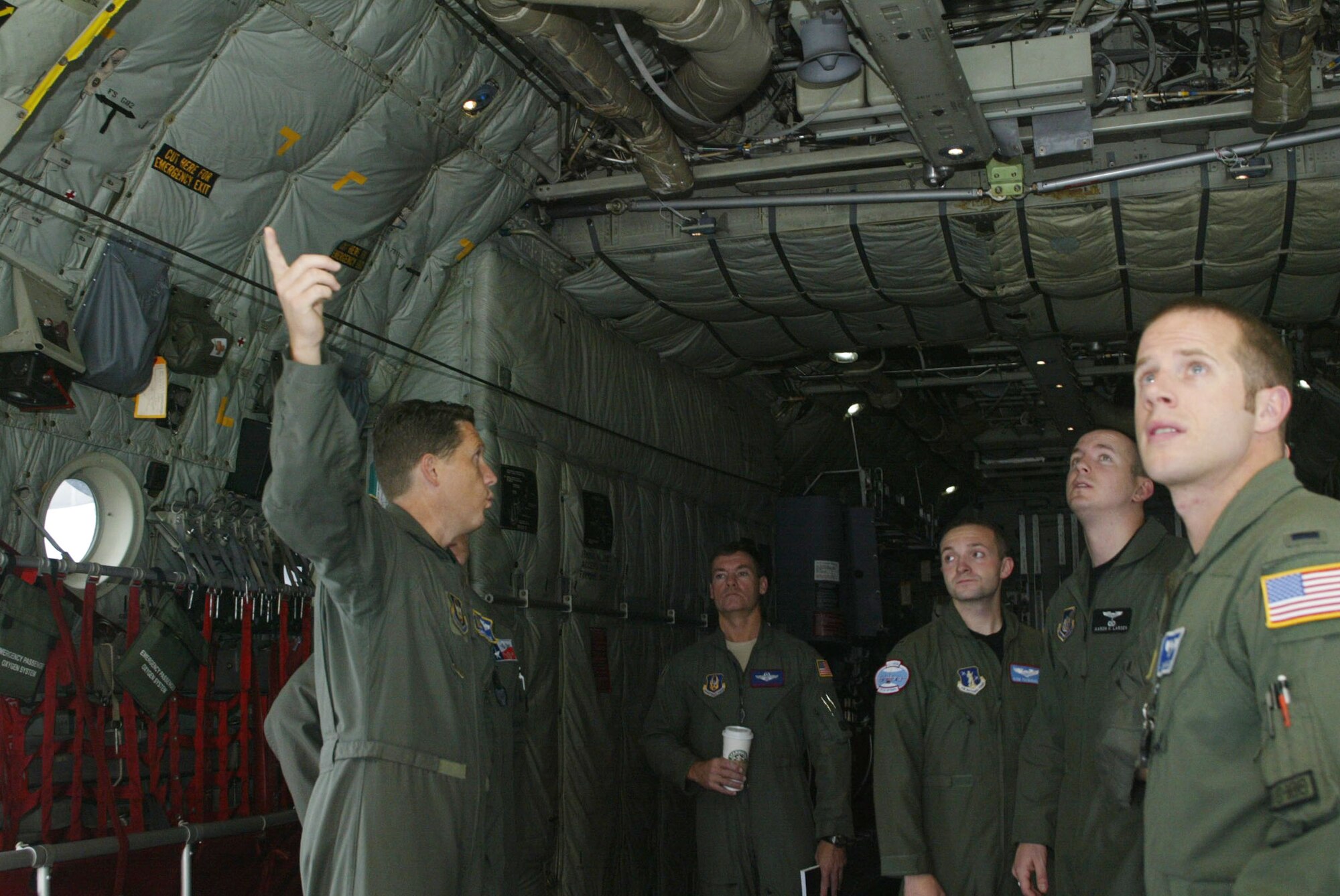 Maj. Christopher Gohlke, 700th Airlift Squadron flight instructor, escorts the newest class of C-130 pilots for a close-up view of their future aircraft Sept. 17. The six student pilots spent the past 10 weeks studying academics and are transitioning into the 20-week portion of hands-on learning to fly the C-130H aircraft assigned here.  After their training, the six pilots will return to Guard and Reserve units throughout the country. (U.S. Air Force photo/Don Peek)