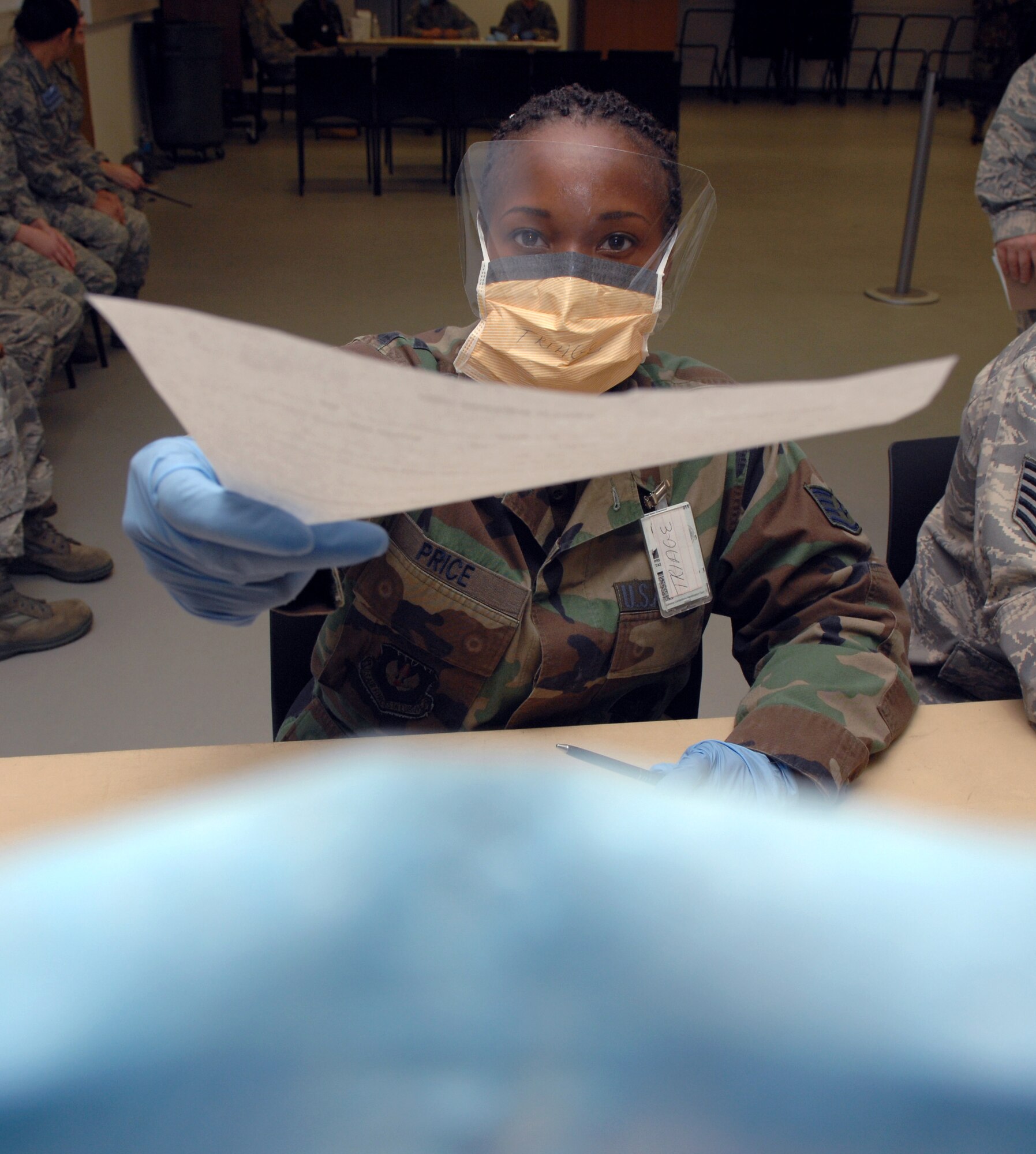 SPANGDAHLEM AIR BASE, Germany – Airman 1st Class Kristopher Kohena, 52nd Equipment Maintenance Squadron, ties on a surgical mask during a Disease Containment Plan Sept 17. Airmen simulated illness to test the 52nd Medical Group’s ability to perform mass prophylaxis which are procedures intended to prevent the spread of disease. Depending on the symptoms, 232 Airmen were routed to different stations to receive situational briefings, triage, medication and/or hospitalization.  (U.S. Air Force photo/Airman 1st Class Staci Miller)