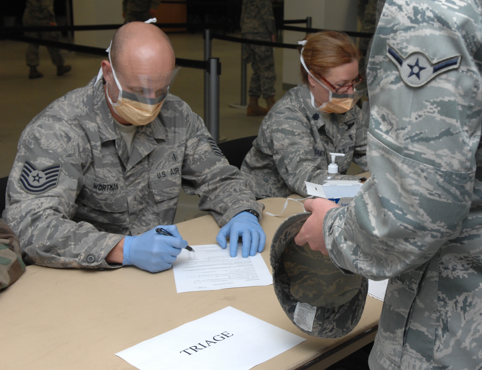 SPANGDAHLEM AIR BASE, Germany – Tech. Sgt. Charles Wortman, 52nd Medical Operations Squadron, performs triage on a patient during a Disease Containment Plan Sept 17. The exercise tested the base’s ability to perform mass prophylaxis which are procedures intended to prevent the spread of disease. The 52nd Medical Group planned and executed situational briefings, triage, medication dispensing and documentation for 232 patients. (U.S. Air Force photo/Airman 1st Class Staci Miller)