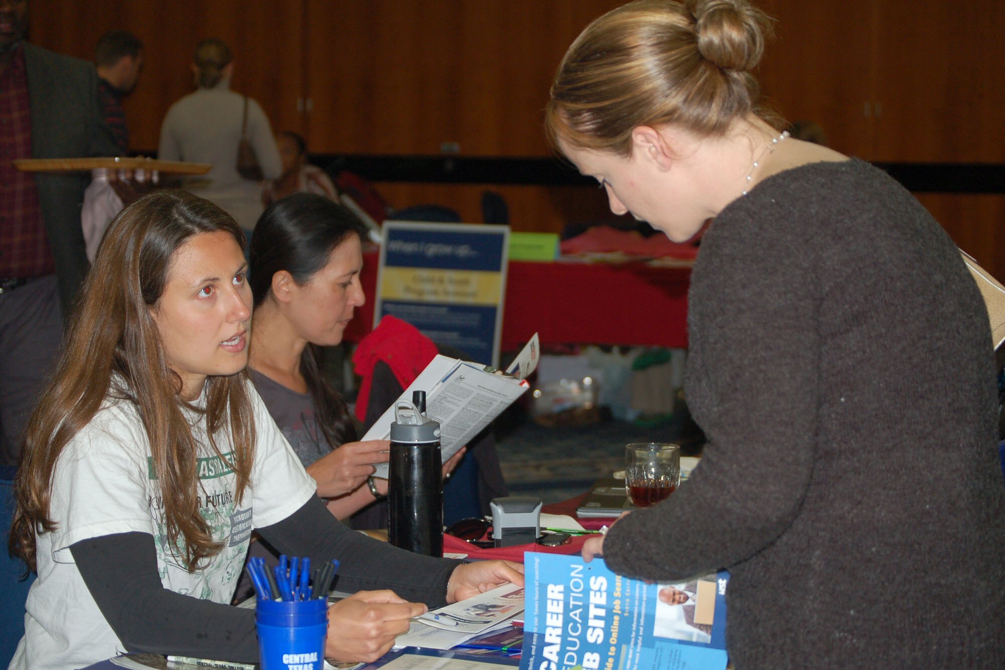 SPANGDAHLEM AIR BASE, Germany – Laurie Clark, Spangdahlem Central Texas College field representative (left), talks to Charlotte Torrez, a Saber spouse, about education opportunities through the college during the Annual Job Fair Sept. 17 at Club Eifel. The event, hosted by the Airmen & Family Readiness Center, provided information about job prospects, career advancement, military spouse benefits, education programs, reintegration programs and volunteer opportunities. (U.S. Air Force photo/Senior Airman Kali L. Gradishar)