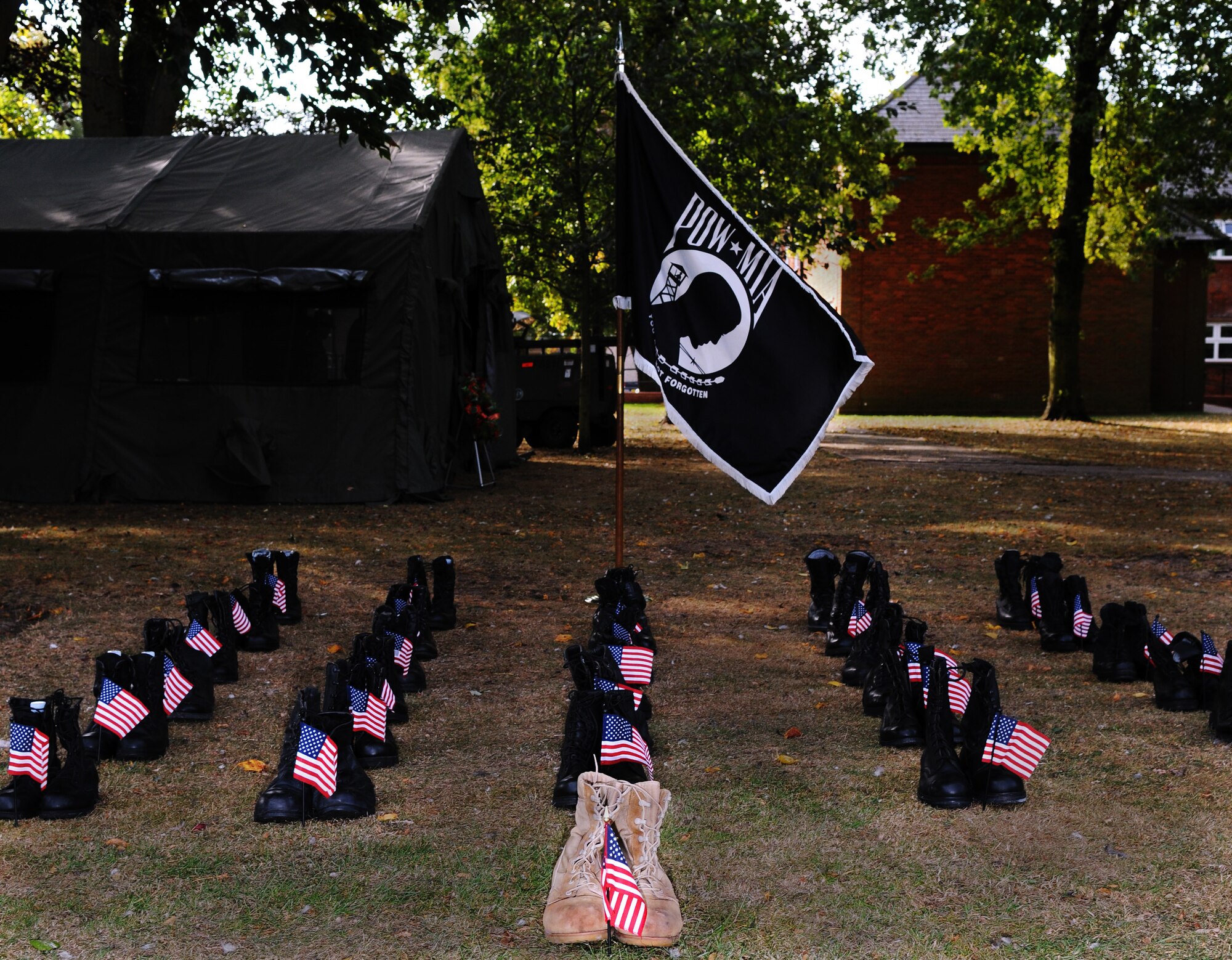 RAF MILDENHALL, England -- A display of combat boots represents military members who have been captured or lost in past wars or conflicts at a 24-hour vigil at the Prisoner of War/Missing in Action memorial here Sept. 17. The base hosted the vigil as part of the annual POW/MIA Week of remembrance week. Volunteers read the names of MIA members before standing guard in front of the memorial. (U.S. Air Force photo/Senior Airman Thomas Trower)