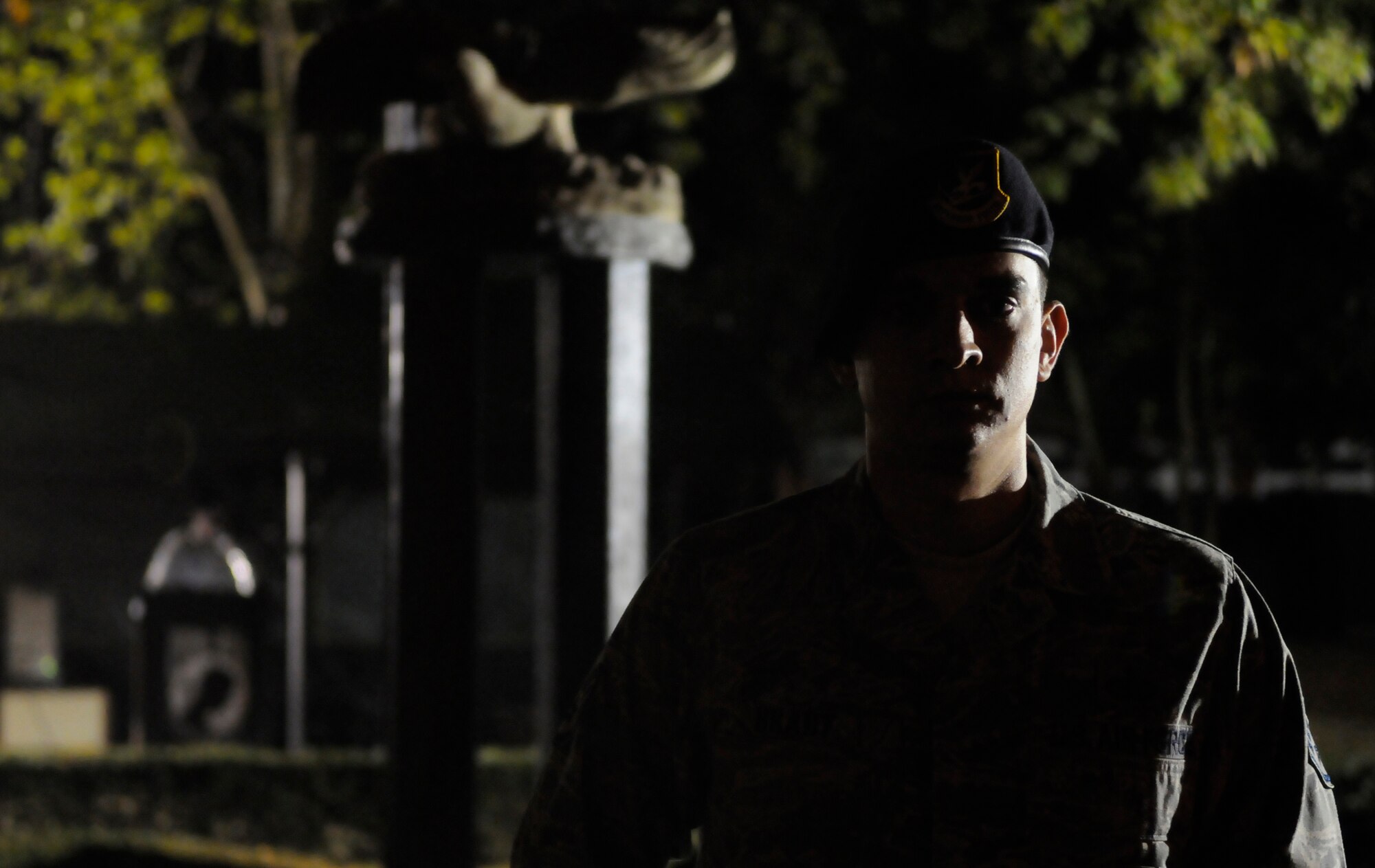 RAF MILDENHALL, England -- Staff Sgt. Phillip Bradt, 100th Security Forces Squadron, stands in silent vigil in honor of prisoners of war and those missing in action Sept. 17. Airmen from RAF Mildenhall gave 10 minutes of their time to support the Prisoner of War/ Missing in Action 24-hour vigil. The base hosted the vigil as part of the annual POW/MIA remembrance week, complete with a display of combat boots to represent the military members who have been captured or lost in past wars or conflicts. Volunteers read names of those still listed as missing for five minutes before standing guard at the memorial until relieved by another volunteer. (U.S. Air Force photo/Staff Sgt. Christopher L. Ingersoll)
