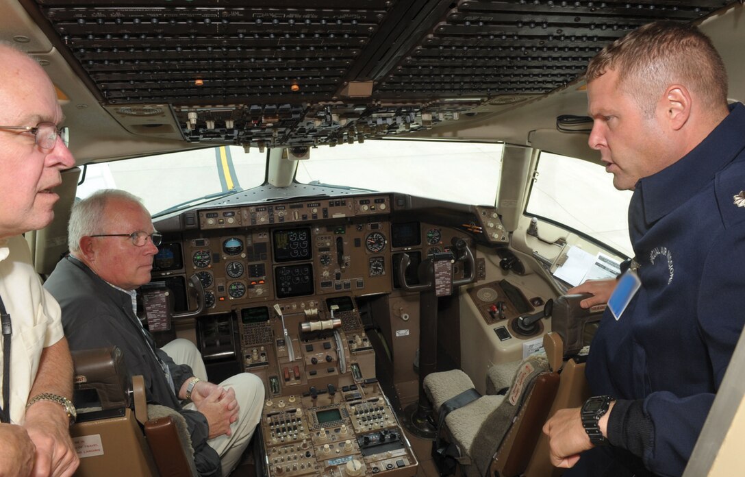 Lieutenant Col. Chris Eden, 1st Airlift Squadron director of programs, speaks with veterans, one of them his father, inside the cockpit of a C-32 during a 40th reunion of the Reese pilot training class of 70-01 tour Saturday. The pilot training class received a mission brief and tour of the C-32 as part of a heritage event. Some notable names among the prestigious group included Gen. Charles Holland (ret.), former Special Operations Command commander; Lt. Col. (ret.) Bill Gauntt, Vietnam prisoner of war; Col. (ret.) Rhip Rowland, an Air Force Cross recipient; and Col. (ret.) Tony Eden, father of Colonel Eden. (U.S. Air Force photo/ Senior Airman Steven R. Doty)