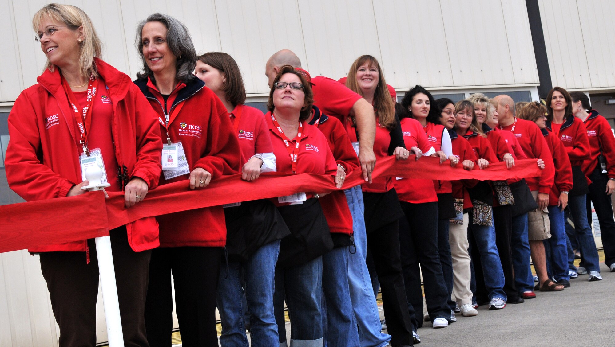 Volunteers for the 45th Annual Ramstein Welfare Bazaar, await the ribbon cutting, Sept. 17, 2009, Ramstein Air Base, Germany. For more than four decades, the Kaiserslautern Military Community has benefited from the Ramstein Welfare Bazaar. This annual event dates back to 1965 and has grown into one of the largest military bazaars in Europe. (U.S. Air Force photo by Senior Airman Nathan Lipscomb)
