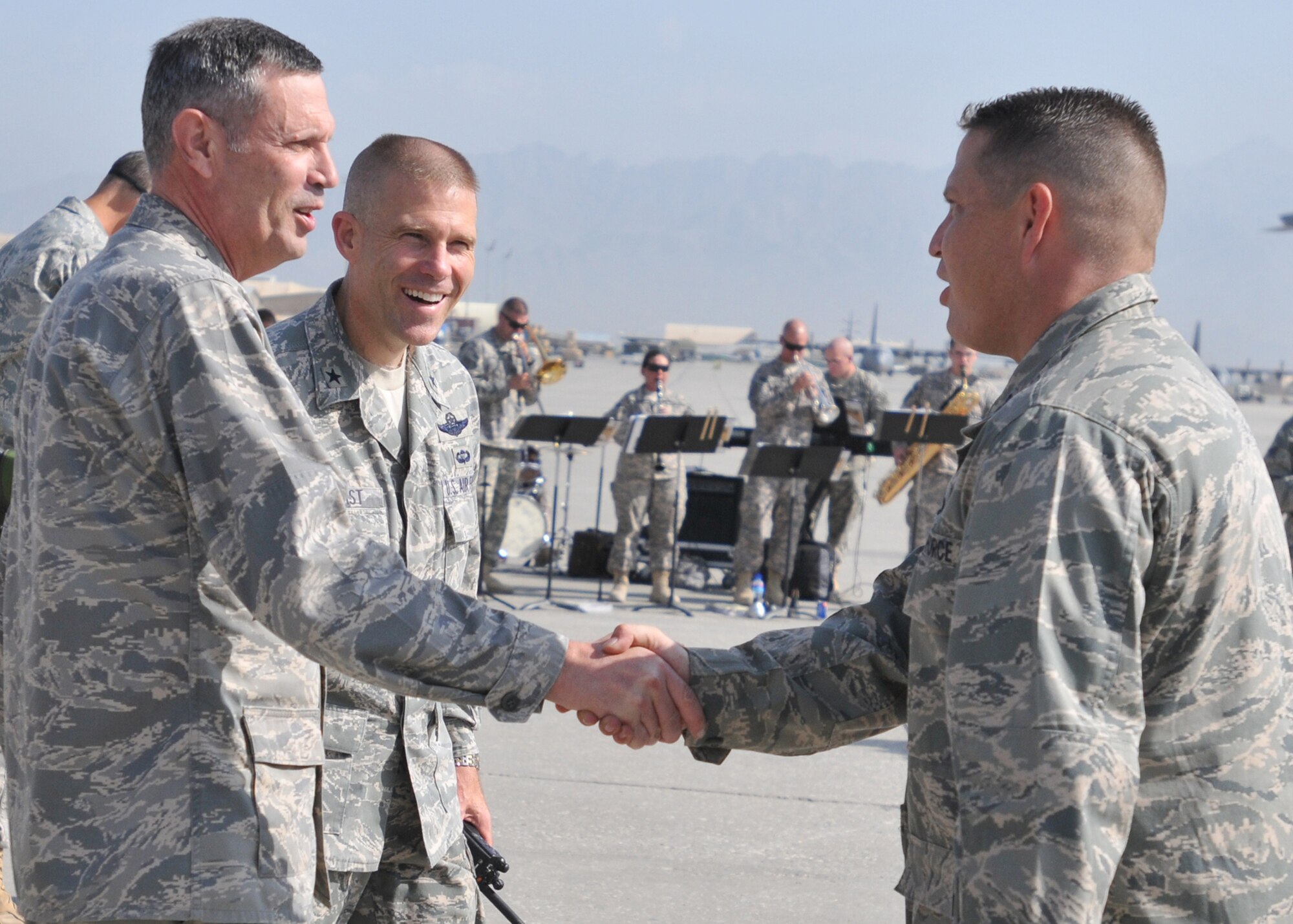 BAGRAM AIRFIELD, Afghanistan --  Lieutenant General John Koziol, Deputy Under Secretary of Defense for Intelligence for Joint and Coalition Warfighter Support and Brig. Gen. Steven Kwast, 455th Air Expeditionary Wing commander thank Capt. Michael Meek, 455th AEW Protocol officer, for his efforts in participating in the organization of the Air Force's 62nd birthday party here,  Sept. 18, 2009.  The 82nd Airborne's band plays patriotic music in the background on the flightline here.  The Air Force birthday events started at 6 a.m. with a military formation of hundreds of Airmen, Soldiers, Sailors and Marines, reveille, a five kilometer run and was later followed by a ceremony and open house with many Air Force aircraft on display.  The open-house event was held for Soldiers, Marines and Sailors to get more acquainted with their Air Force counterparts who are often providing support from the sky, or from remote bases scattered across Afghanistan.  (U.S. Air Force photo/Capt. David Faggard)