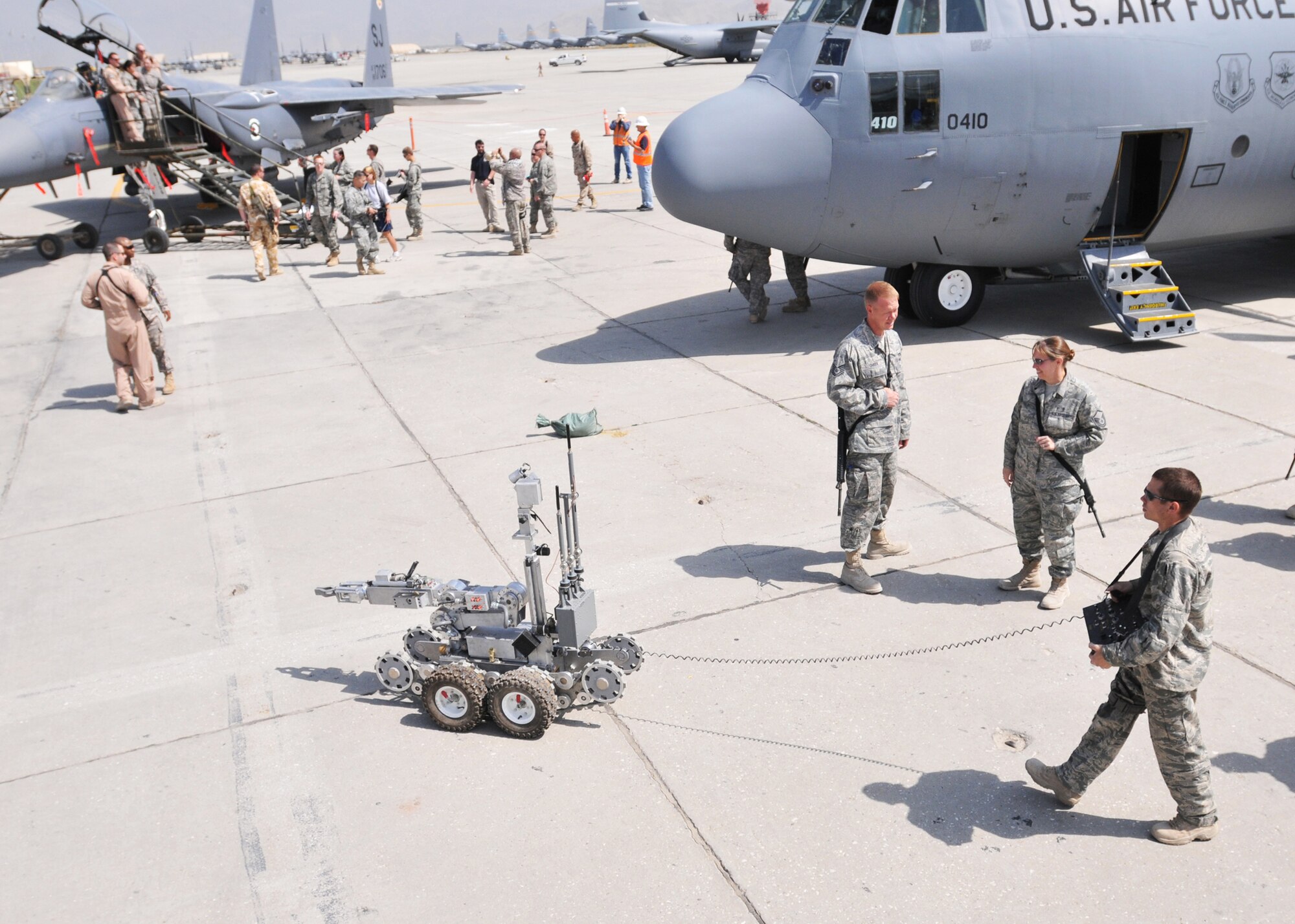 BAGRAM AIRFIELD, Afghanistan -- Staff Sgt. Ryan Oliver, an Explosive Ordnance Disposal team leader from the 755th Air Expeditionary Group demonstrates the capabilities of their robot for a crowd here at an Open House ceremony in honor of the Air Force's 62nd birthday here, Sept. 18, 2009.  The Air Force birthday events started at 6 a.m. with a military formation of hundreds of Airmen, Soldiers, Sailors and Marines, reveille, a five kilometer run and was later followed by a ceremony and open house with many Air Force aircraft on display.  The open-house event was held for Soldiers, Marines and Sailors to get more acquainted with their Air Force counterparts who are often providing support from the sky, or from remote bases scattered across Afghanistan.  (U.S. Air Force photo/Captain David Faggard)