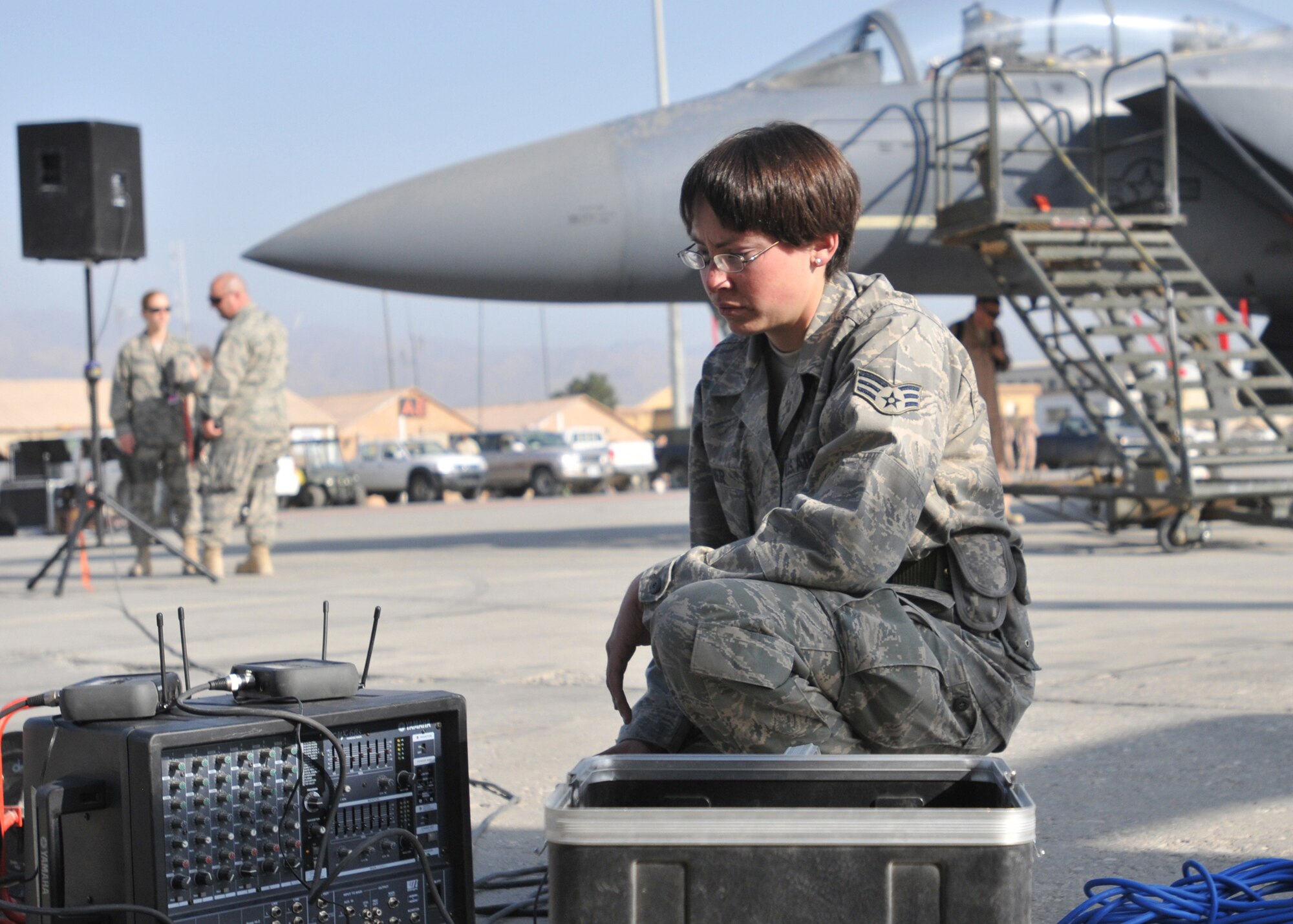 BAGRAM AIRFIELD, Afghanistan-- Senior Airman Stephanie Warner, a technician in the 455th Expeditionary Communications Squadron, does one final test on the Public Address system at an Open House ceremony in honor of the Air Force's 62nd birthday here, Sept. 18, 2009.  The Air Force birthday events started at 6 a.m. with a military formation of hundreds of Airmen, Soldiers, Sailors and Marines, reveille, a five kilometer run and was later followed by a ceremony and open house with many Air Force aircraft on display.  The open-house event was held for Soldiers, Marines and Sailors to get more acquainted with their Air Force counterparts who are often providing support from the sky, or from remote bases scattered across Afghanistan.  (U.S. Air Force photo/Capt. David Faggard)
