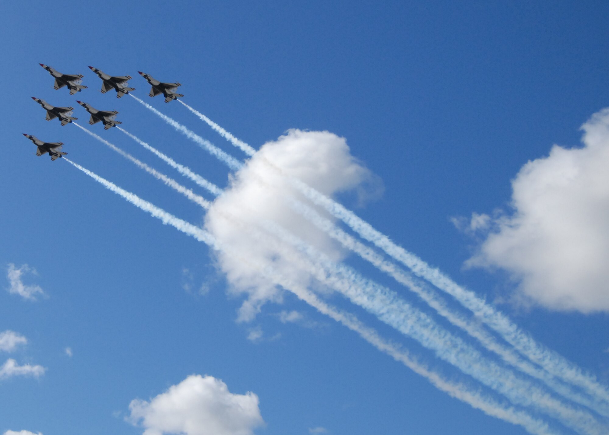 HICKAM AIR FORCE BASE, Hawaii -- The Thunderbirds, U.S. Air Force Demonstration Squadron, arrive in typical style over Hickam Air Force Base, Hawaii, during their initial arrival for "Wings Over the Pacific," Sept. 16. The Thunderbirds will demonstrate the capabilities the F-16 Fighting Falcon by performing combat maneuvers during their aerial portion of the weekend event Sept. 19-20. This is Hickam?s first open house since 2003, and a crowd of more than 120,000 are expected to visit during the weekend.  (U.S. Air Force photo/Staff Sgt. Mike Meares)