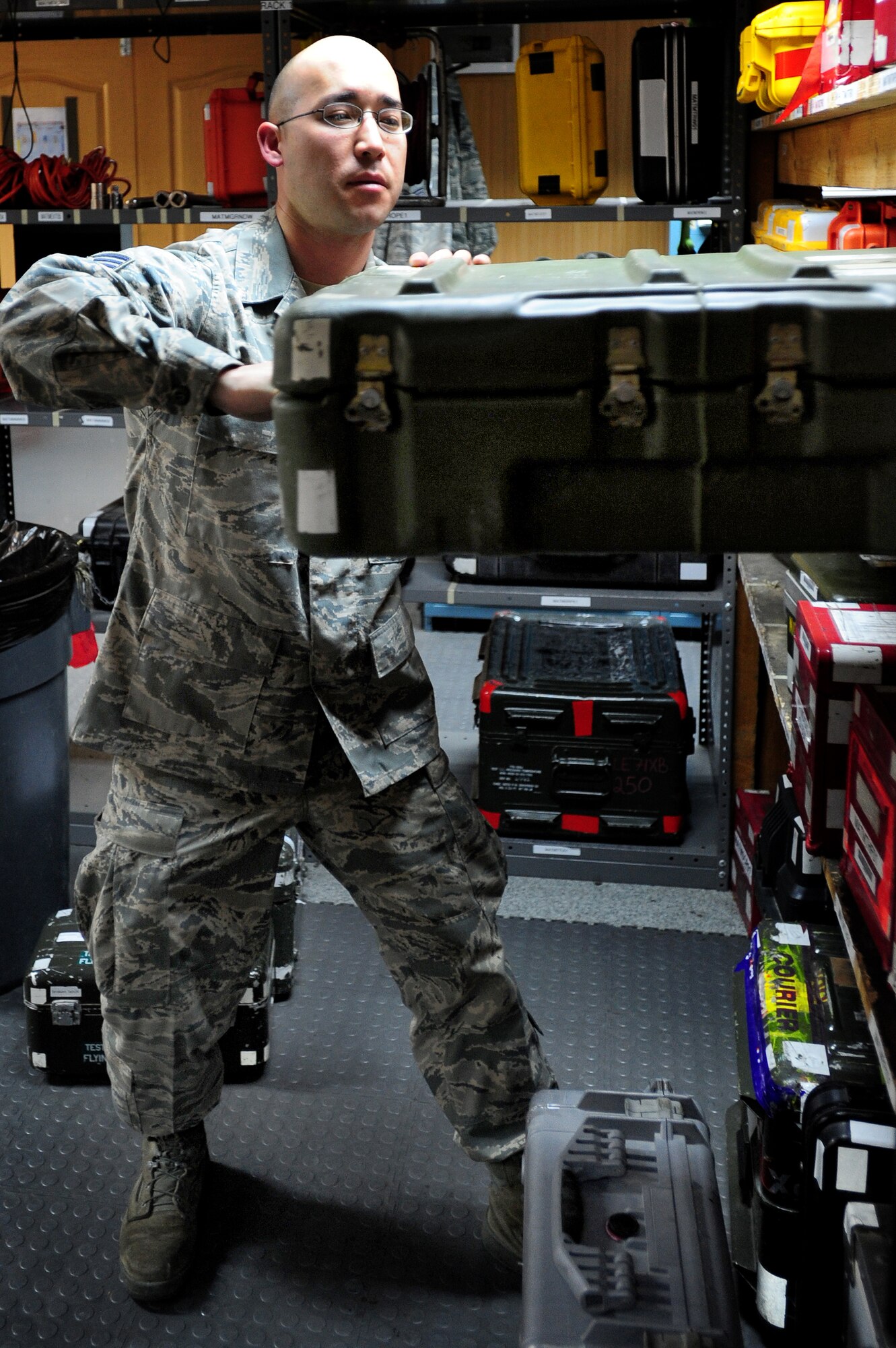 TRANSIT CENTER AT MANAS, Kyrgyzstan -- Senior Airman Kevin Eberhart, 376th Expeditionary Aircraft Maintenance Squadron tanker support, pulls a transfer gear box change kit from the shelf at the Transit Center. Airman Eberhart ensures all equipment is properly accounted for before issuing and receiving kits from maintainers at Manas. He is deployed from the 92nd AMXS located at Fairchild Air Force Base, Wash. and is originally from O'ahu, Hawaii. (U.S. Air Force photo/Senior Airman Steele C. G. Britton)