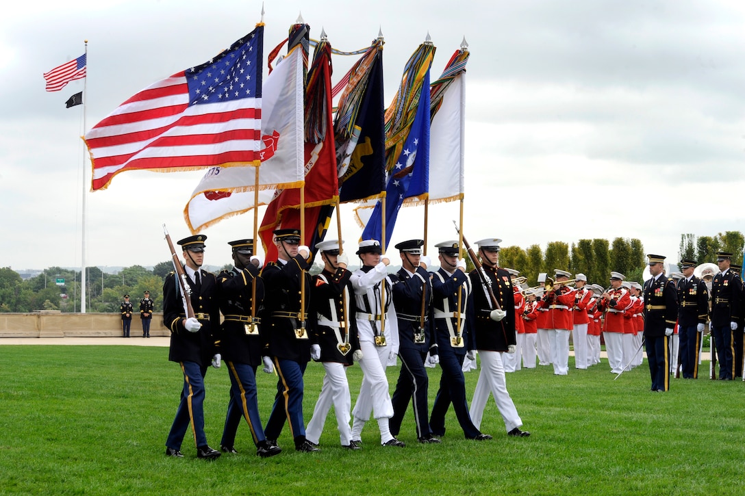 Members of a joint color guard march onto the field during the National POW/MIA Recognition Day ceremony at the Pentagon, Sept. 18, 2009.