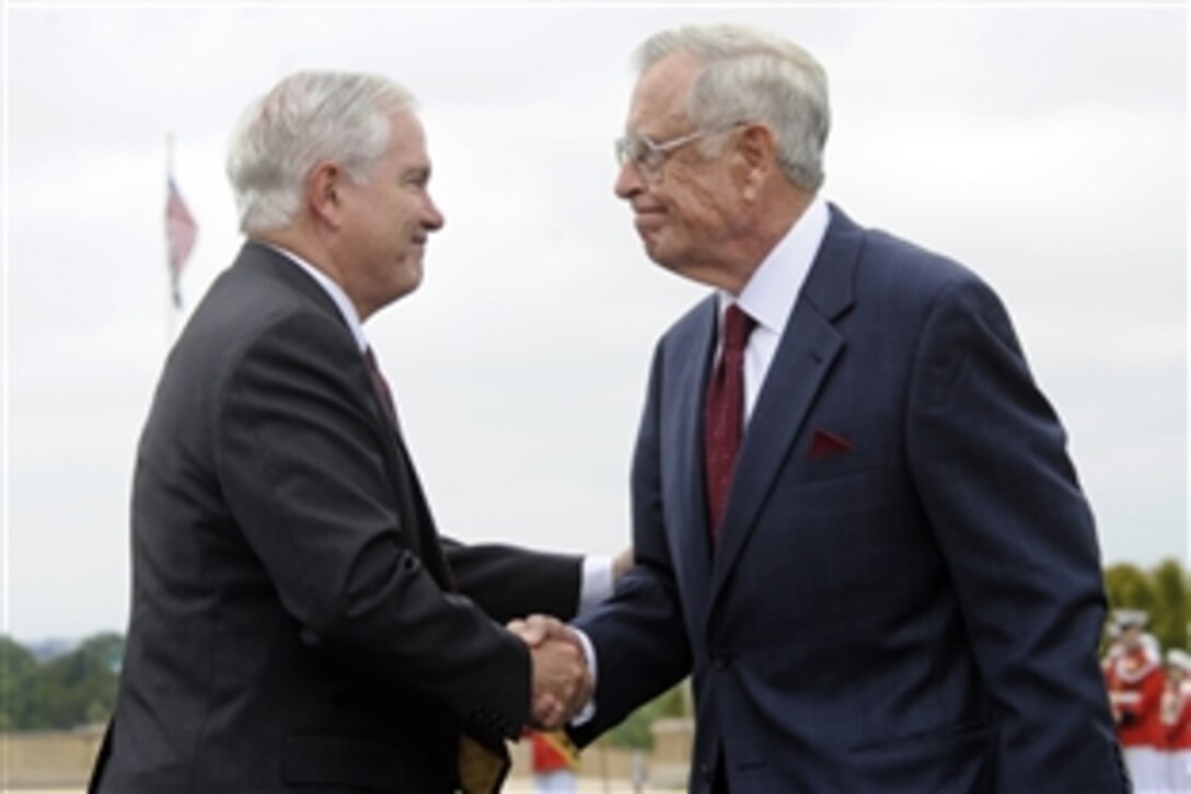 Defense Secretary Robert M. Gates shakes hands with retired Rear Adm. Jeremiah A. Denton Jr. during the National POW/MIA Recognition Day Ceremony at the Pentagon, Sept. 18, 2009. Denton spent seven years and seven months as a prisoner of war when he was shot down and captured by North Vietnamese troops in 1965.