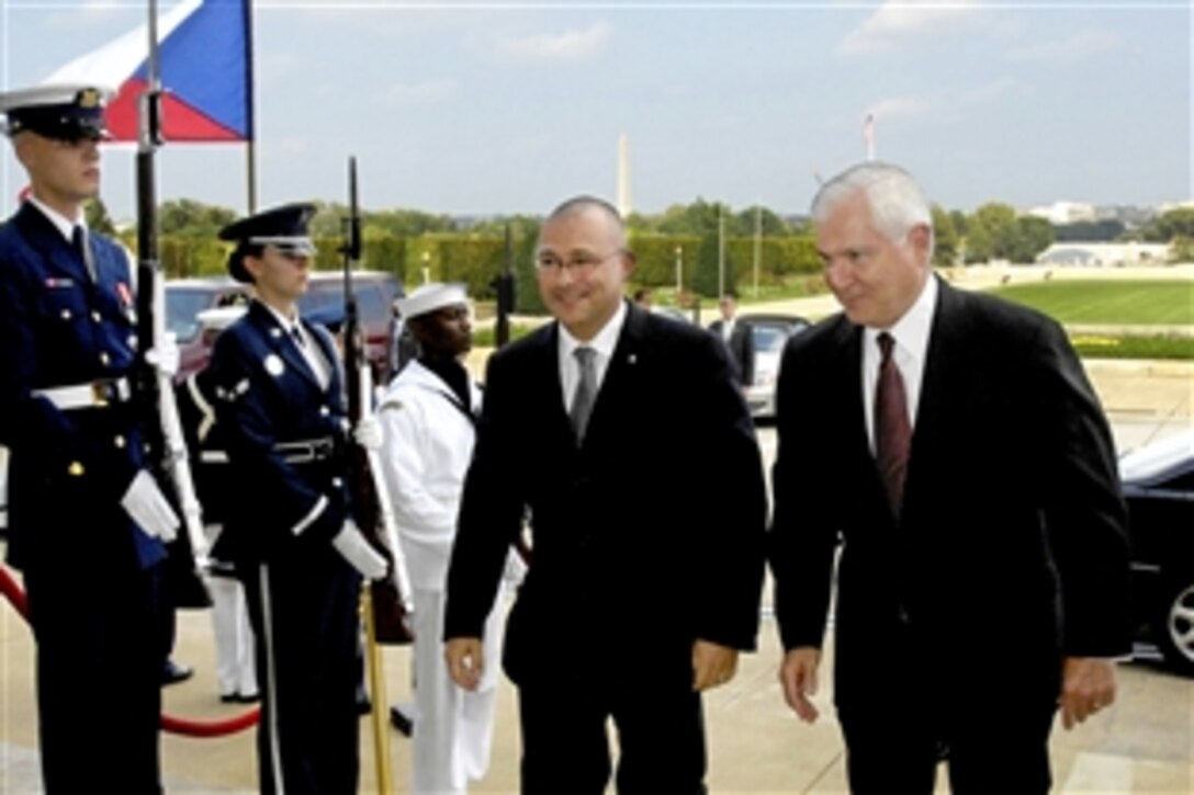 Defense Secretary Robert M. Gates escourts visiting Czech Defense Minister Martin Bartak through a cordon of honor guards into the Pentagon, Sept. 18, 2009.  The two defense leaders  discussed the Obama Administration's latest decisions regarding missile defense technologies.