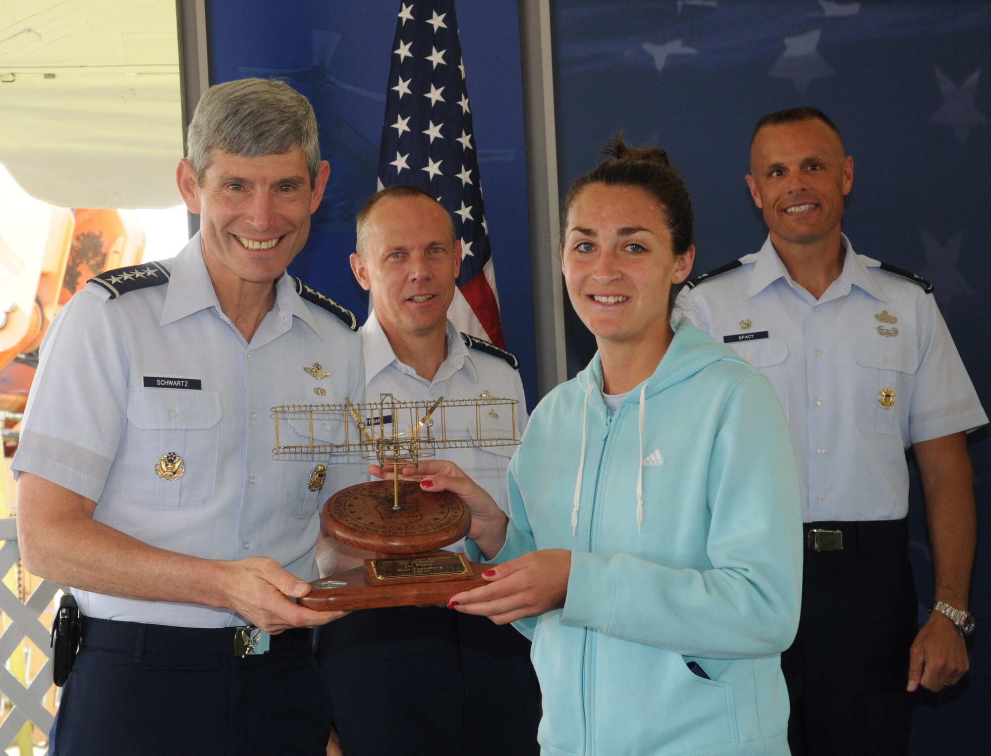 Gen. Norton Schwartz, Air Force Chief of Staff, gives a trophy to Kate Papenberg, the female winner of the full marathon.  (US Air Force photo by Al Bright)