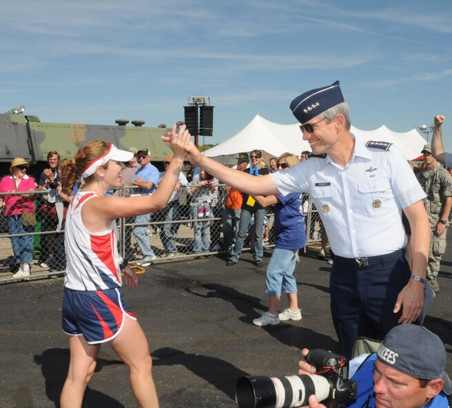 Gen. Norton Schwartz, Air Force Chief of Staff, gives a high five to one of the full marathon runners crossing the finish line. (Air Force photo by Al Bright) 