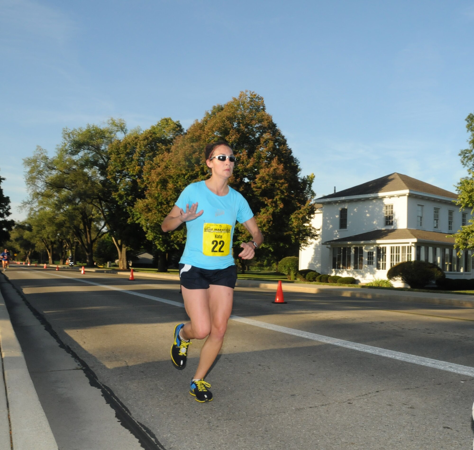 Kate Papenberg, the female winner of the full marathon, passes the Arnold House at approximately the 8.5 mile mark.  The oldest building on Wright-Patterson, the house is named for Gen. Henry ‘Hap’ Arnold who lived there while he was base commander.  (US Air Force photo by Al Bright)