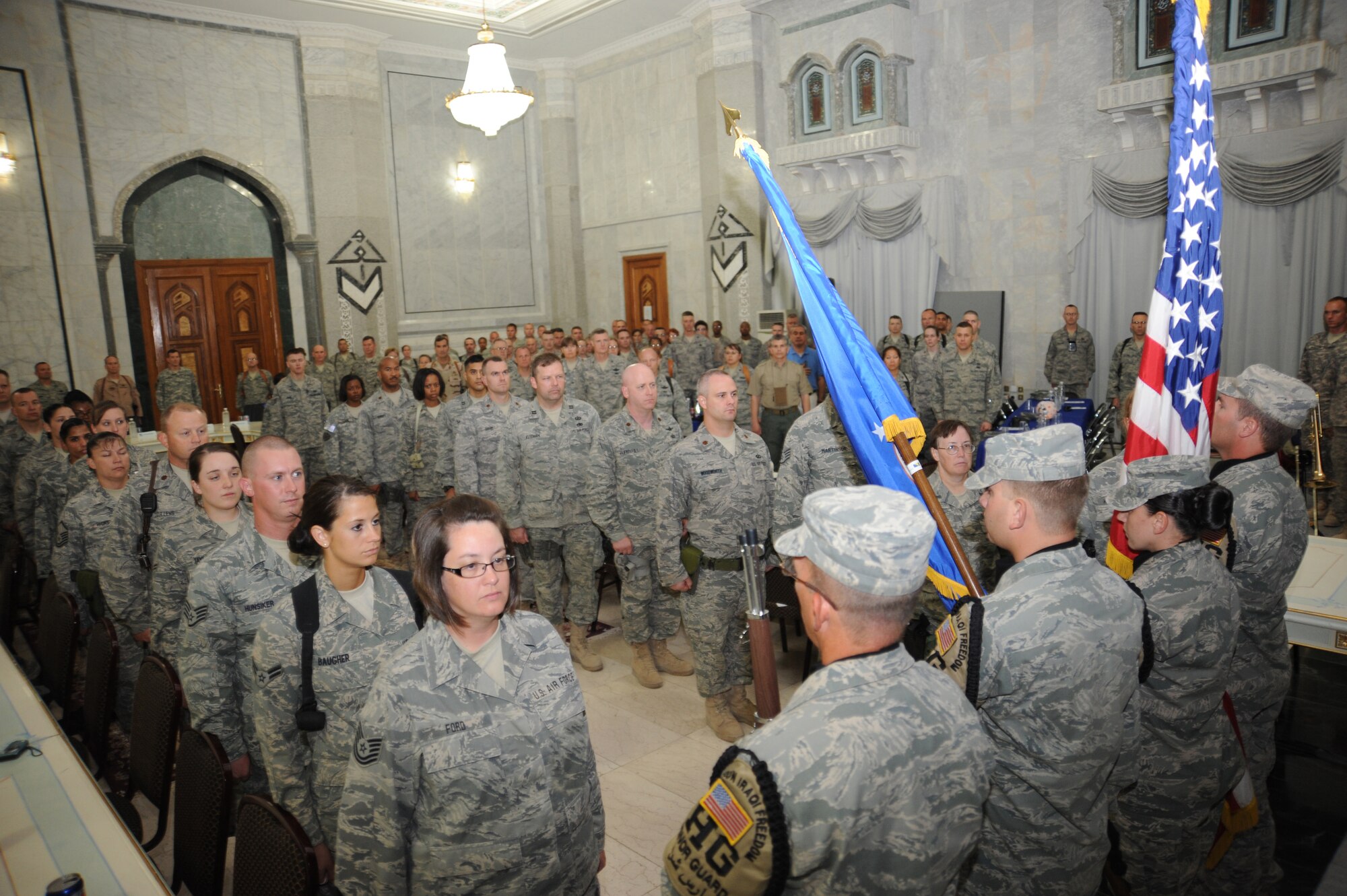 CAMP VICTORY, Iraq -- Members of the Sather Air Base honor guard post the colors while more than 200 servicemembers stand at attention during the opening of the Air Force's 62nd birthday celebration held at the Al Faw palace here Sept. 18, 2009. Lt. Gen. Mike Hostage, Air Force Central Command commander, was in attendance as well as Maj. Gen. Joseph Reynes Jr., Air Component Coordination Element director, who served as the keynote speaker for the evening. (U.S. Air Force photo/Tech. Sgt. Johnny L. Saldivar)