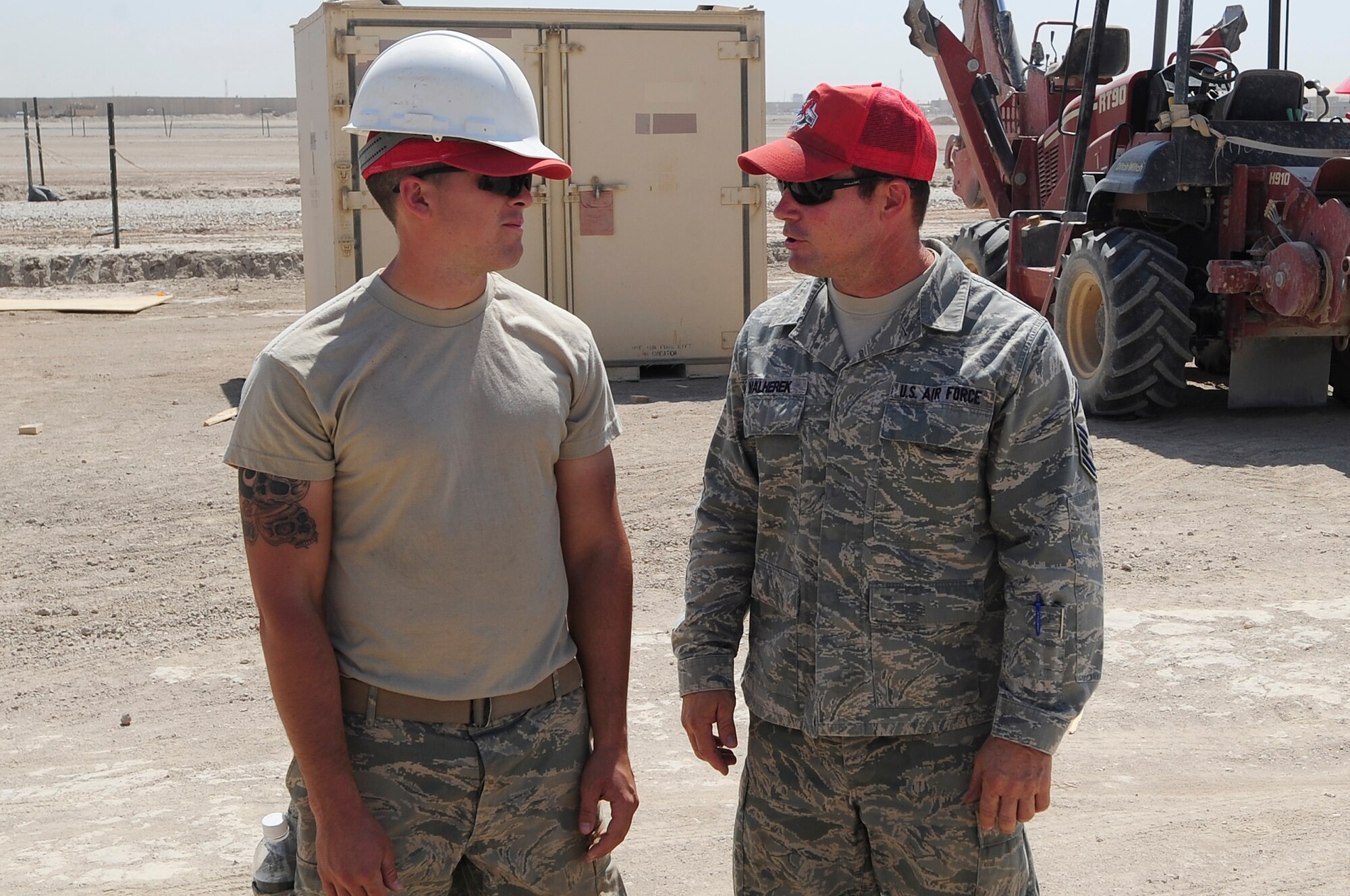 ALI BASE, Iraq - U.S. Air Force Senior Master Sgt. Jeff Malherek, site superintendent, 557th Expeditionary Red Horse Squadron, communicates with one of his Airman on a construction site Sep. 2, 2009. Sergeant Malherek is originally from Riverton, Minn. and is deployed here from Aviano Air Base, Italy.  (U.S. Air Force photo / Airman 1st Class Tony R. Ritter)