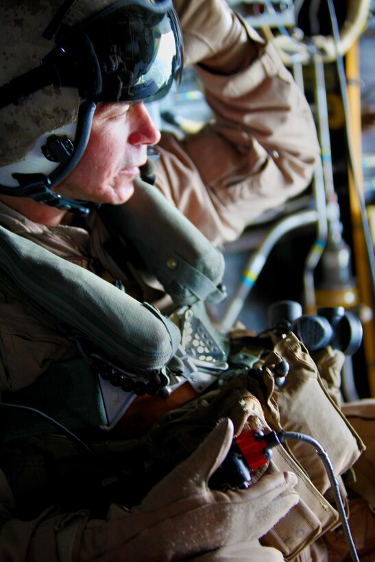 Sgt. Maj. Jon W. Turner, Marine Medium Tiltrotor Squadron 266 sergeant major, looks out the back of an MV-22B Osprey above Marine Corps Air Station New River, N.C., Aug. 10, 2011. The visit was hosted by Marine Medium Tiltrotor Squadron 266 for the 26th MEU Command Element to get a better understanding of the 26th MEU's future Aviation Combat Element's capabilities. (U.S. Marine Corps photo by Cpl. Christopher Stone/Released)