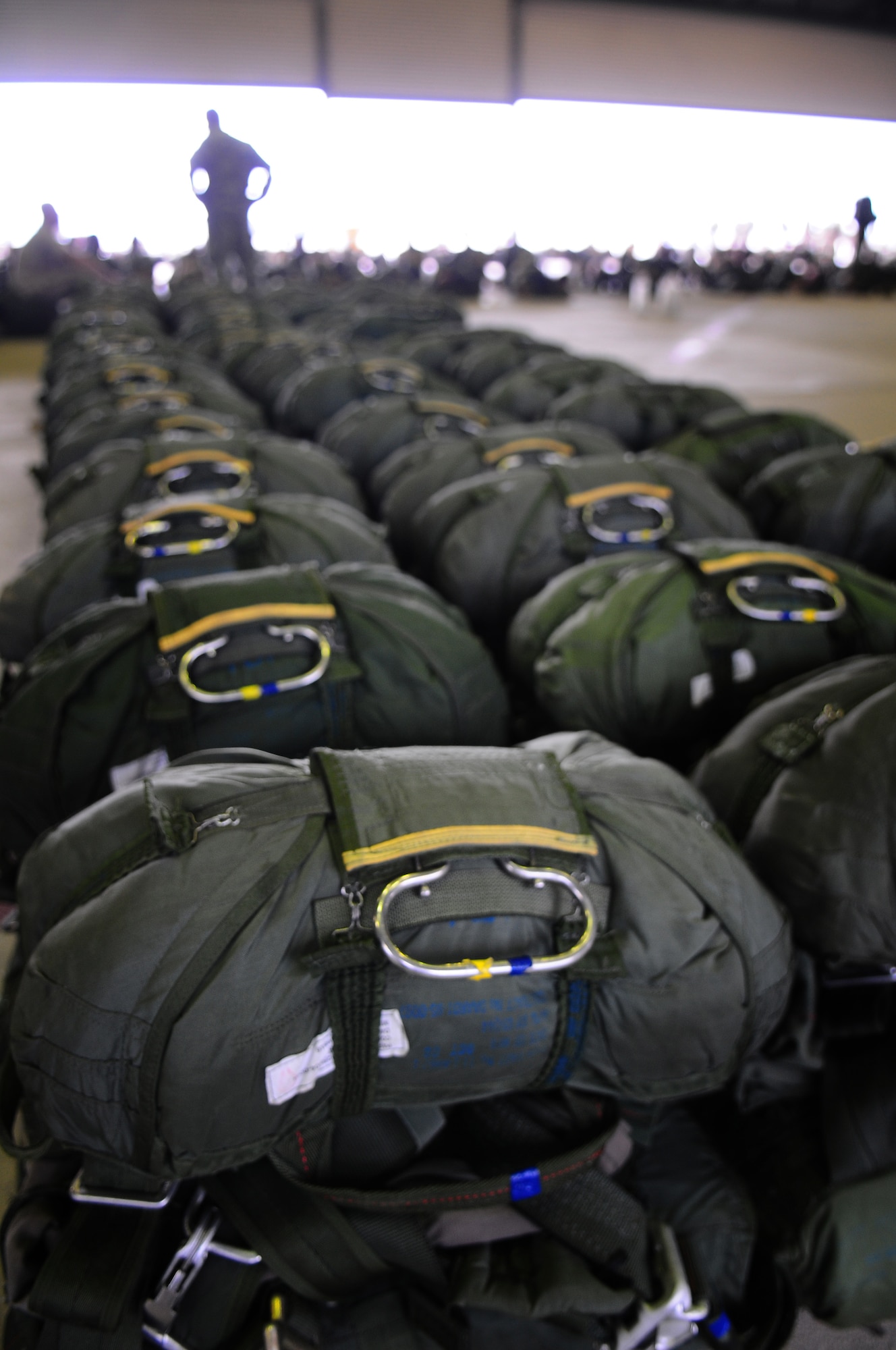 Rows of parachutes are lined up ready to be worn by paratroopers from six countries participating in the over 1,000-person jump over Arnhem, Holland, Sept. 19, 2009.  The event commemorated the 65th anniversary of Operation Market Garden. (U.S. Air Force photo by Staff Sgt. Jocelyn Rich) 
