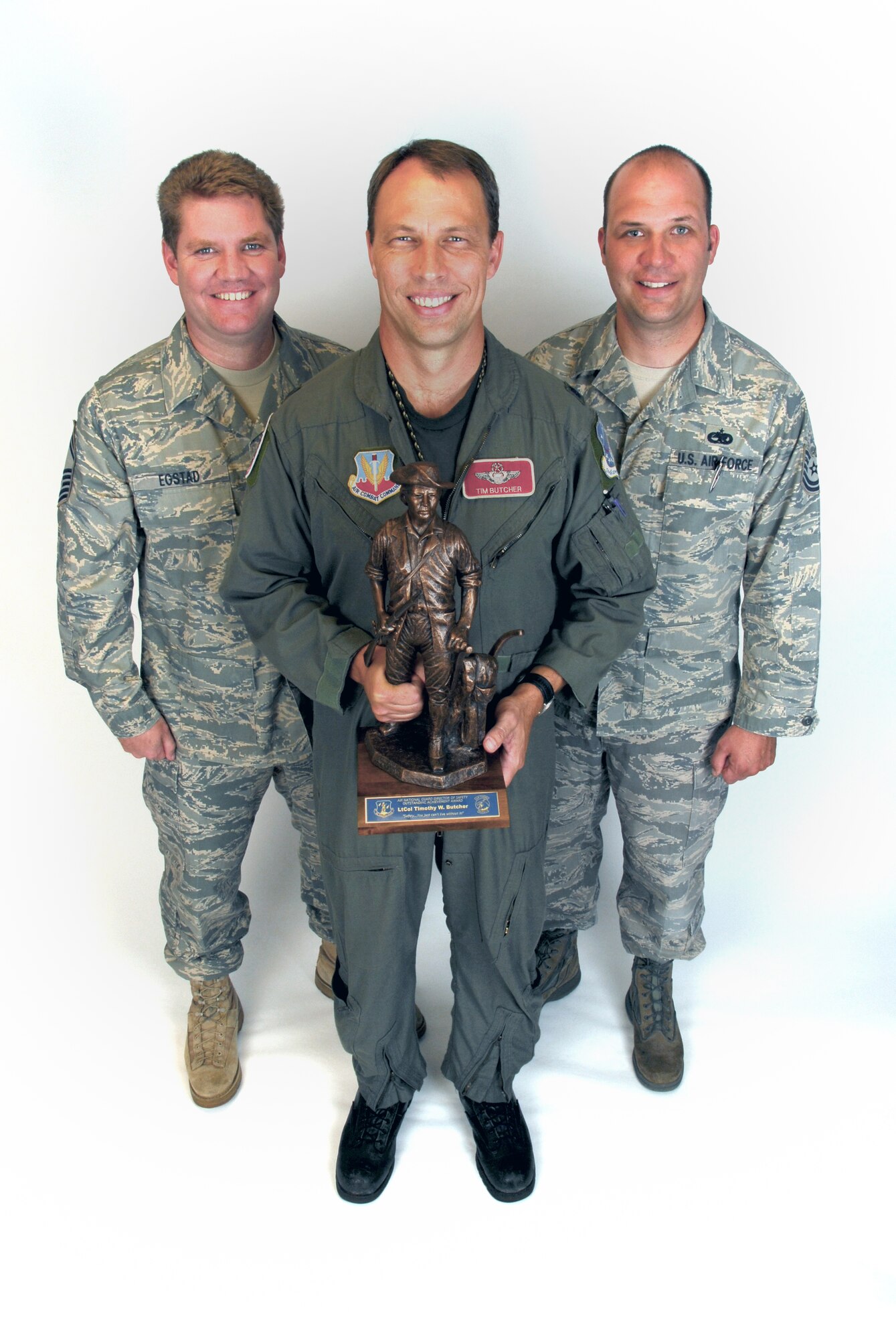 Senior Master Sgt. Thomas Egstad, left, and Tech. Sgt. Jason Kasten, right, stand with Lt. Col. Timothy Butcher after Butcher was presented wtih the Air National Guard Outstanding Safety Achievement Award.  (U.S. Air Force photo by Staff Sgt. Ashley Bell)