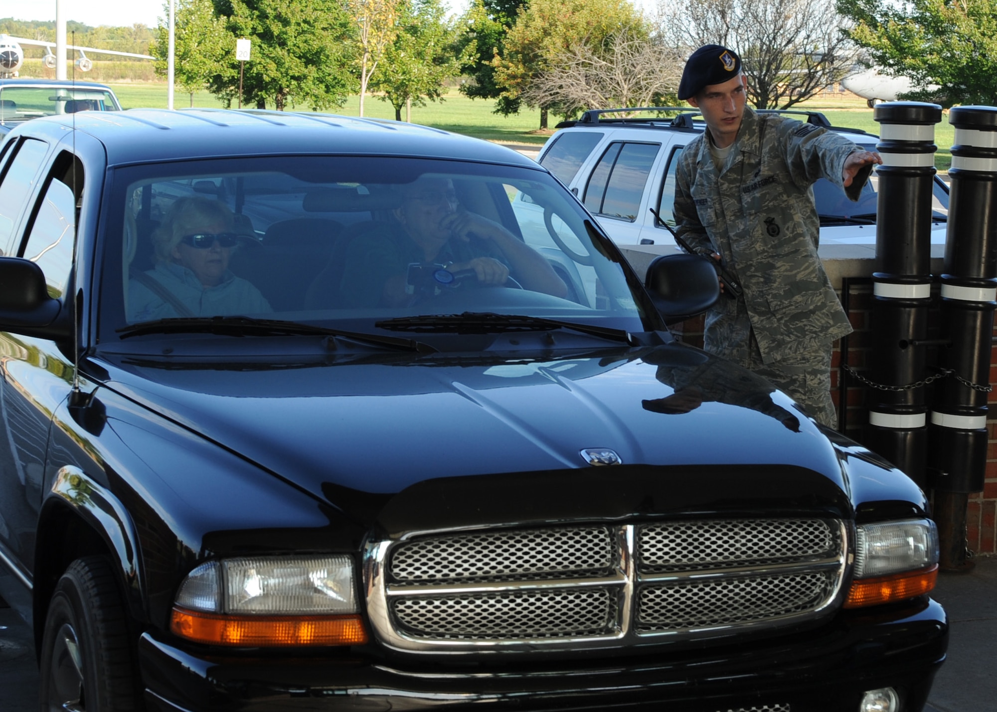 SCOTT AIR FORCE BASE, Ill. -- Staff Sgt. Russell Clevenger, 375th Security Forces Squadron patrolman, gives directions to parking at the Shiloh gate of Scott to Air show attendee's on Saturday. The yearly show brought in approximately 60,000 people on the first of the two day event. (U.S. Air Force photo/Airman 1st Class Wesley P. Farnsworth)