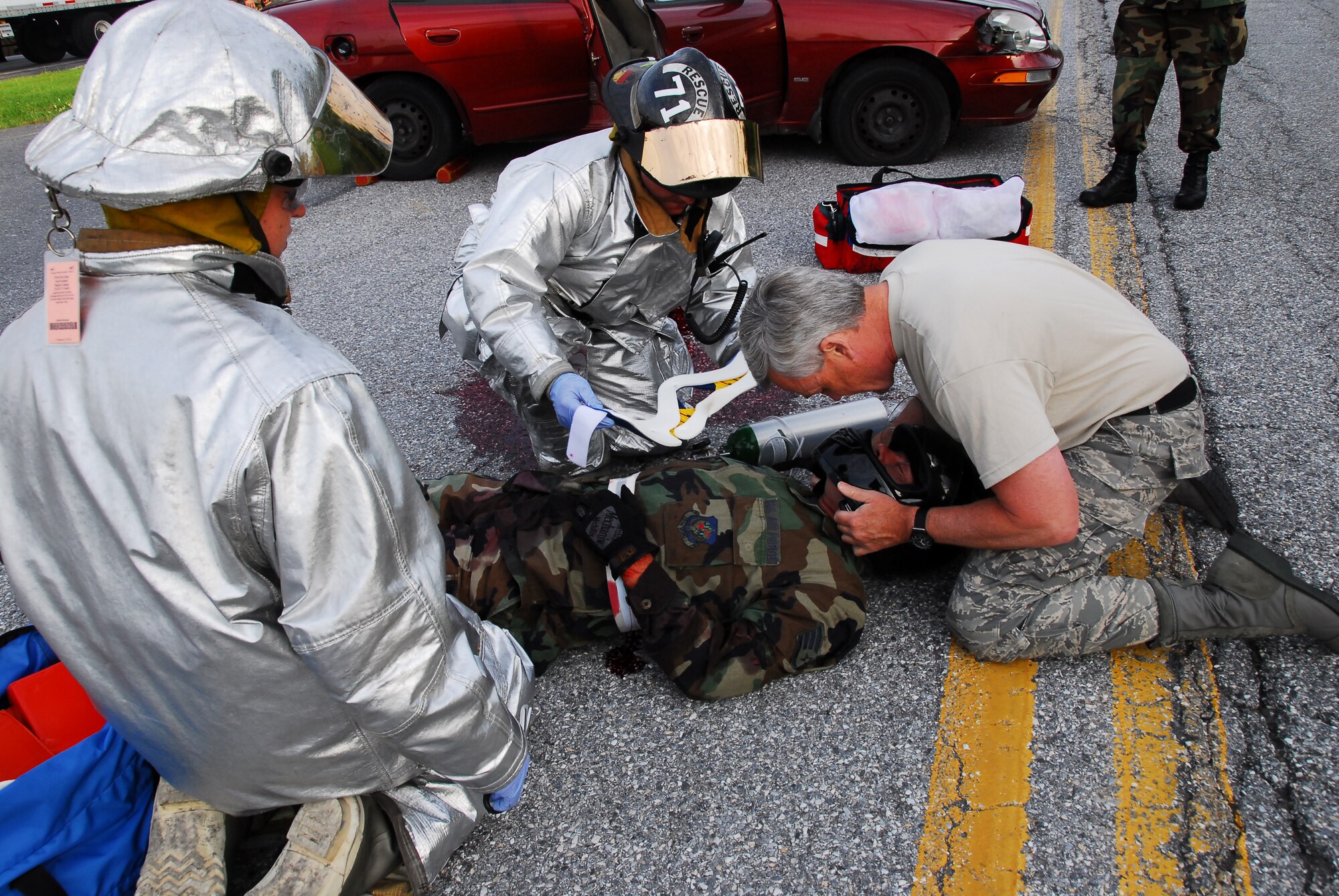 193rd Special Operations Wing guardmen, Lieutenant Colonel Thomas Ladley from the medical group and two Airmen from civil engineer fire, assists an Airman acting to be injured from a motorcycle accident. The exercise was done the morning of drill on June 08, 2008, while Airmen were driving into work to, show why motorists should be cautious, especially those to those on motorcycles. 