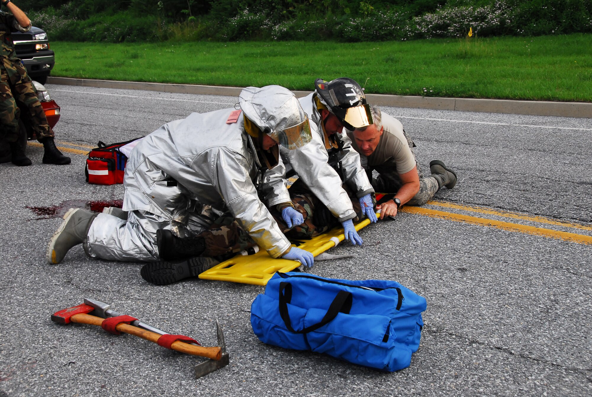 193rd Special Operations Wing guardmen, Lieutenant Colonel Thomas Ladley from the medical group and two Airmen from civil engineer fire, assists an Airman acting to be injured from a motorcycle accident. The exercise was done the morning of drill on June 08, 2008, while Airmen were driving into work to, show why motorists should be cautious, especially those to those on motorcycles. 